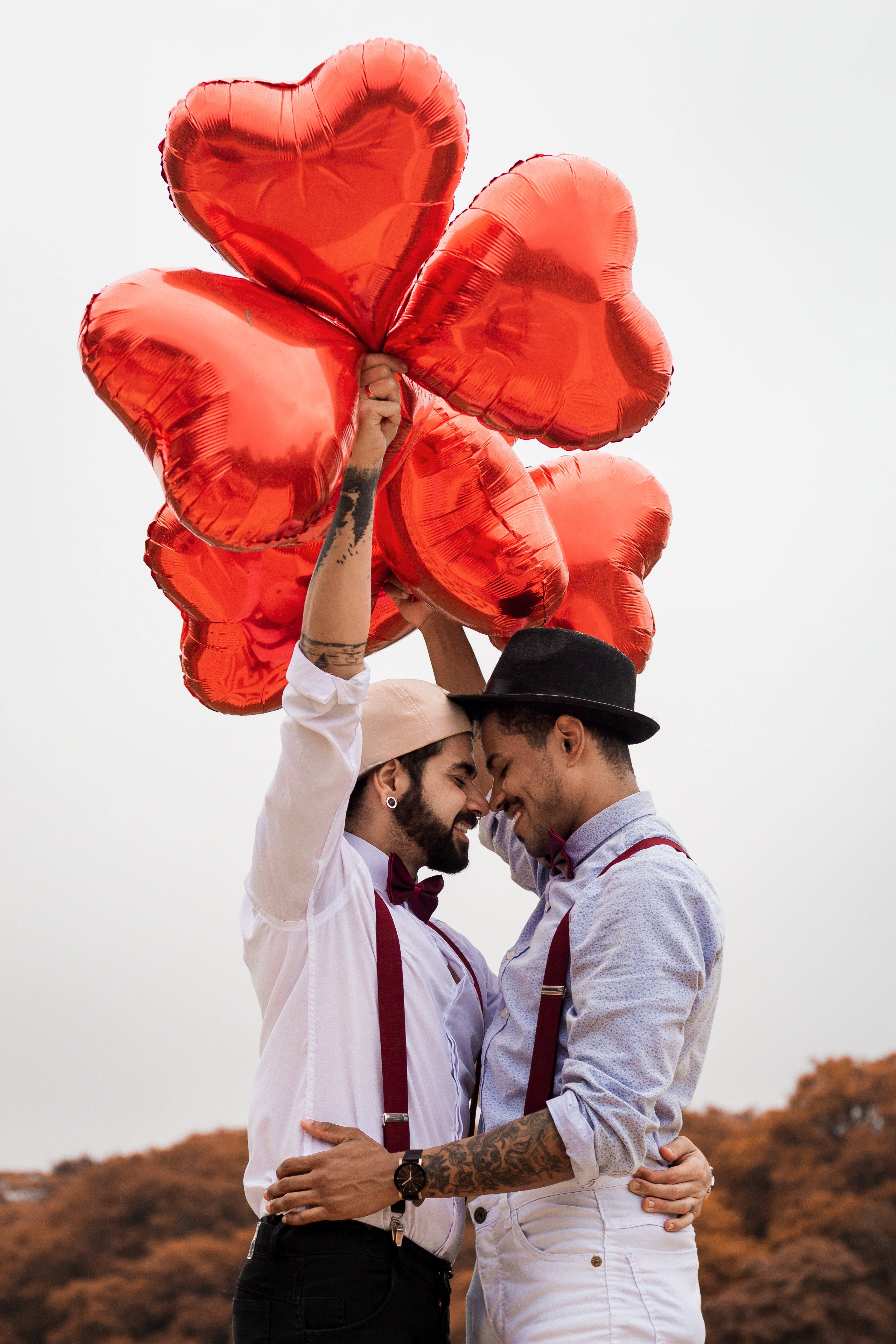 LGBTQ+ couple, men in suspenders, shiny red heart-shaped balloons, 5K Phone Wallpaper