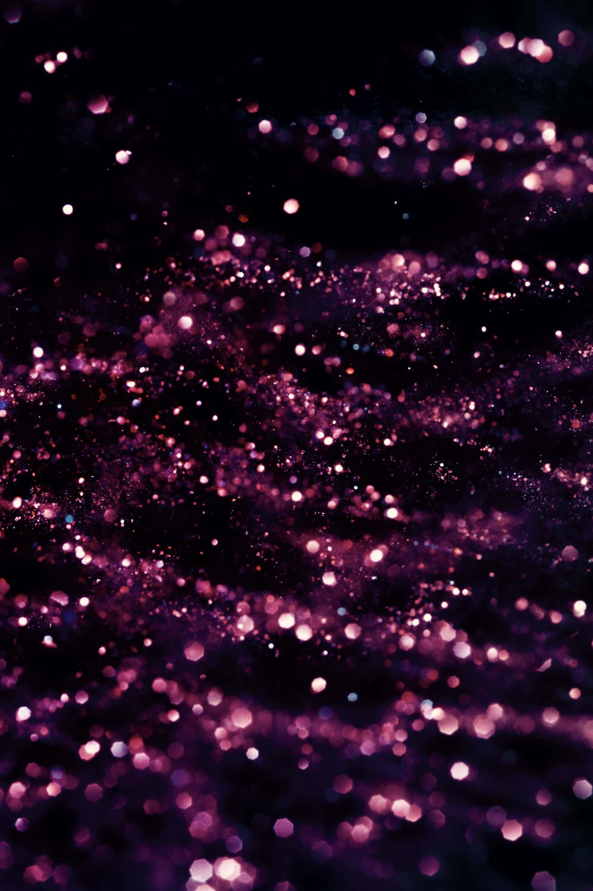 Black And Pink iPhone, glowing purple glitter particles, deep black background, 2K Phone Wallpaper