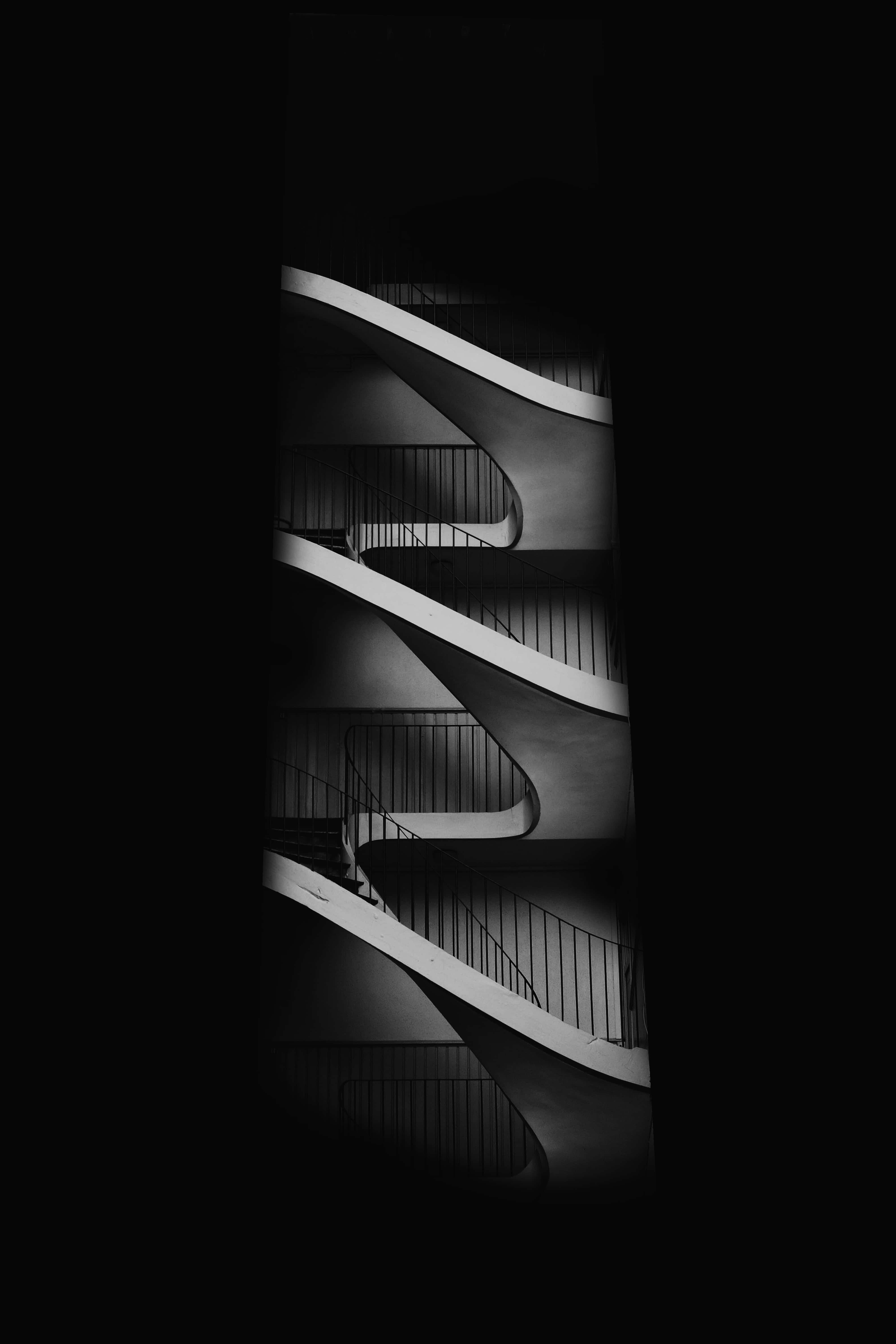 black and white spiral staircase, deep shadowed background, dramatic, 5K Phone Wallpaper