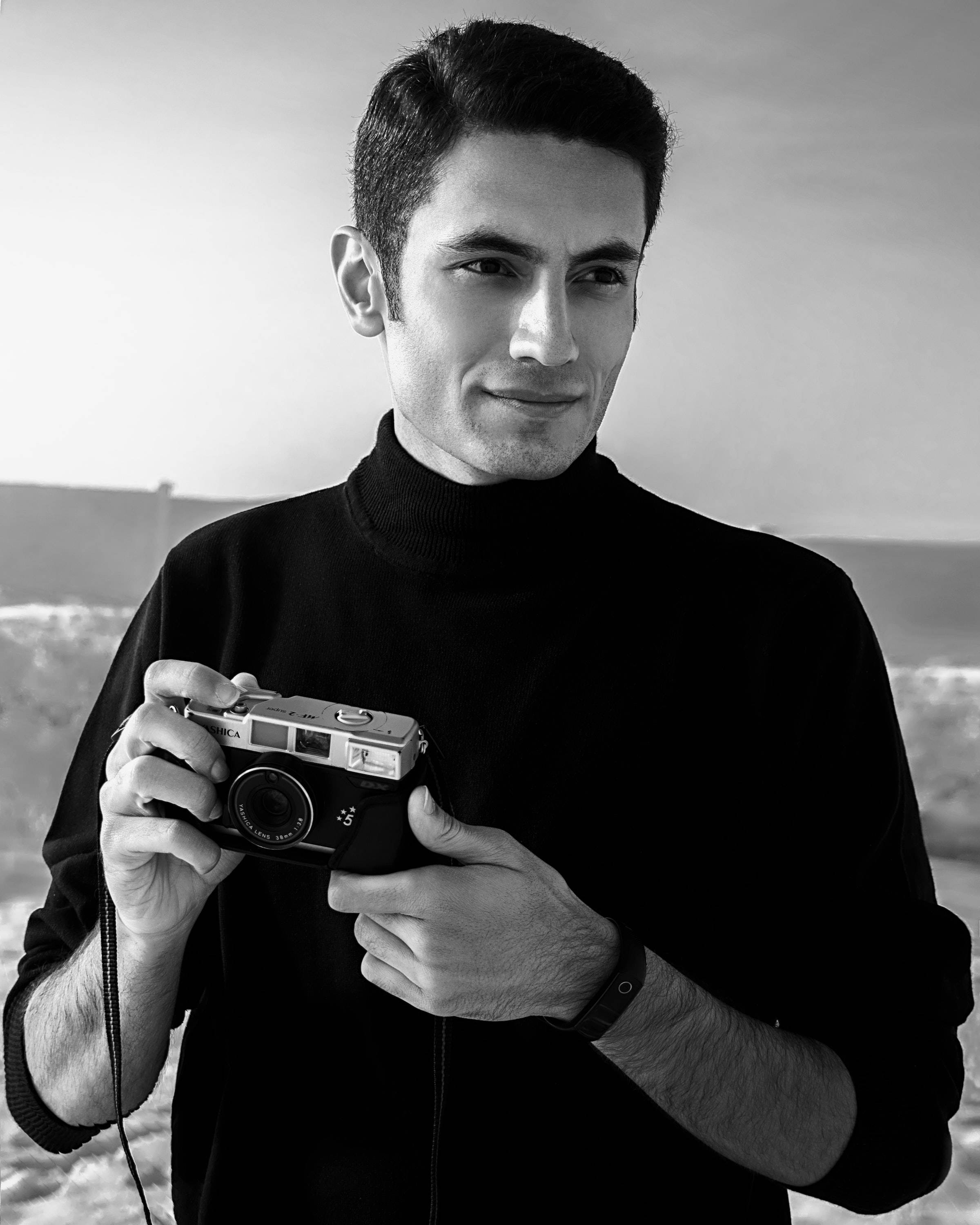 black and white portrait, man with a camera, black turtleneck, 2K Phone Wallpaper