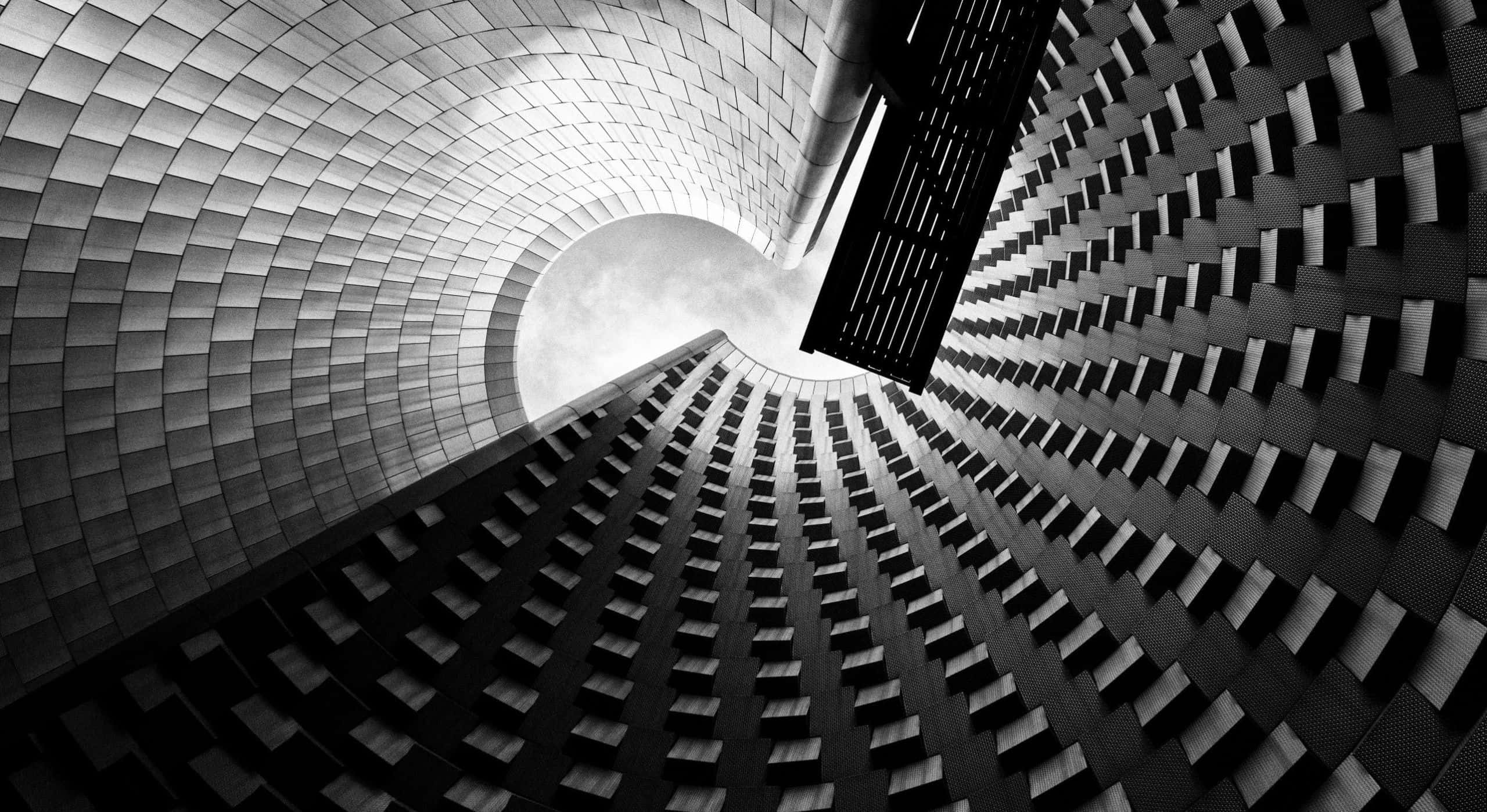 black and white architecture, spiraling modern building facade, low-angle shot, 2K Desktop Wallpaper