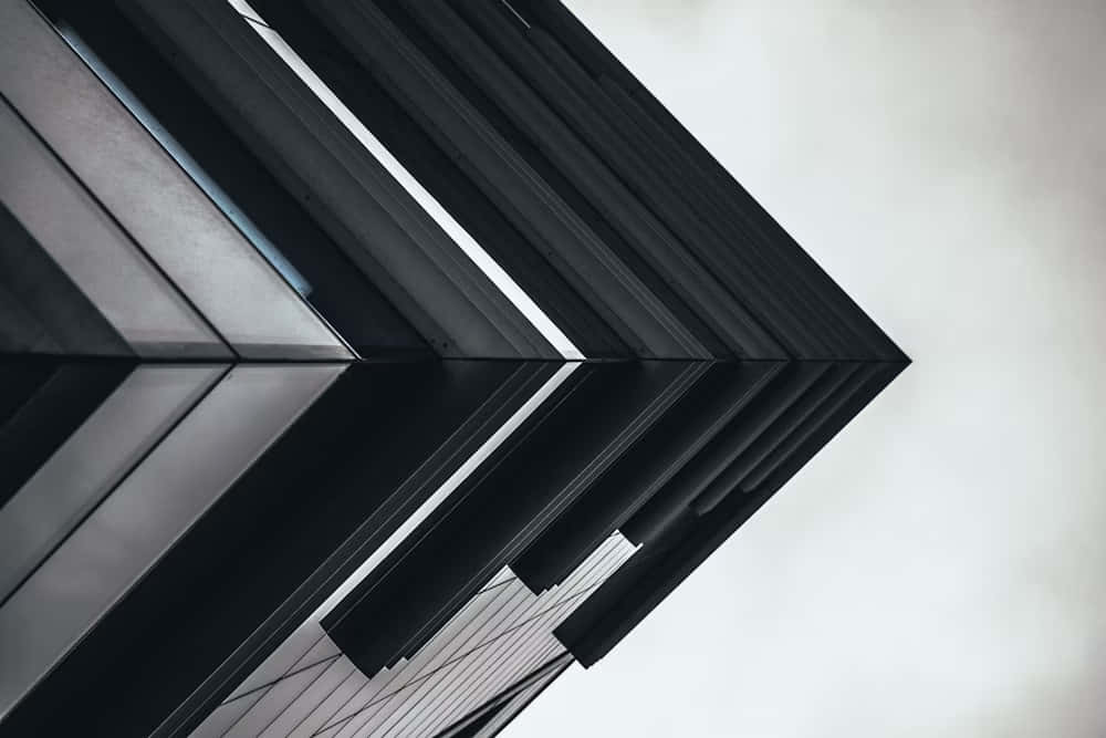 abstract modern architecture, black geometric facade, pale overcast sky, SD Desktop Wallpaper