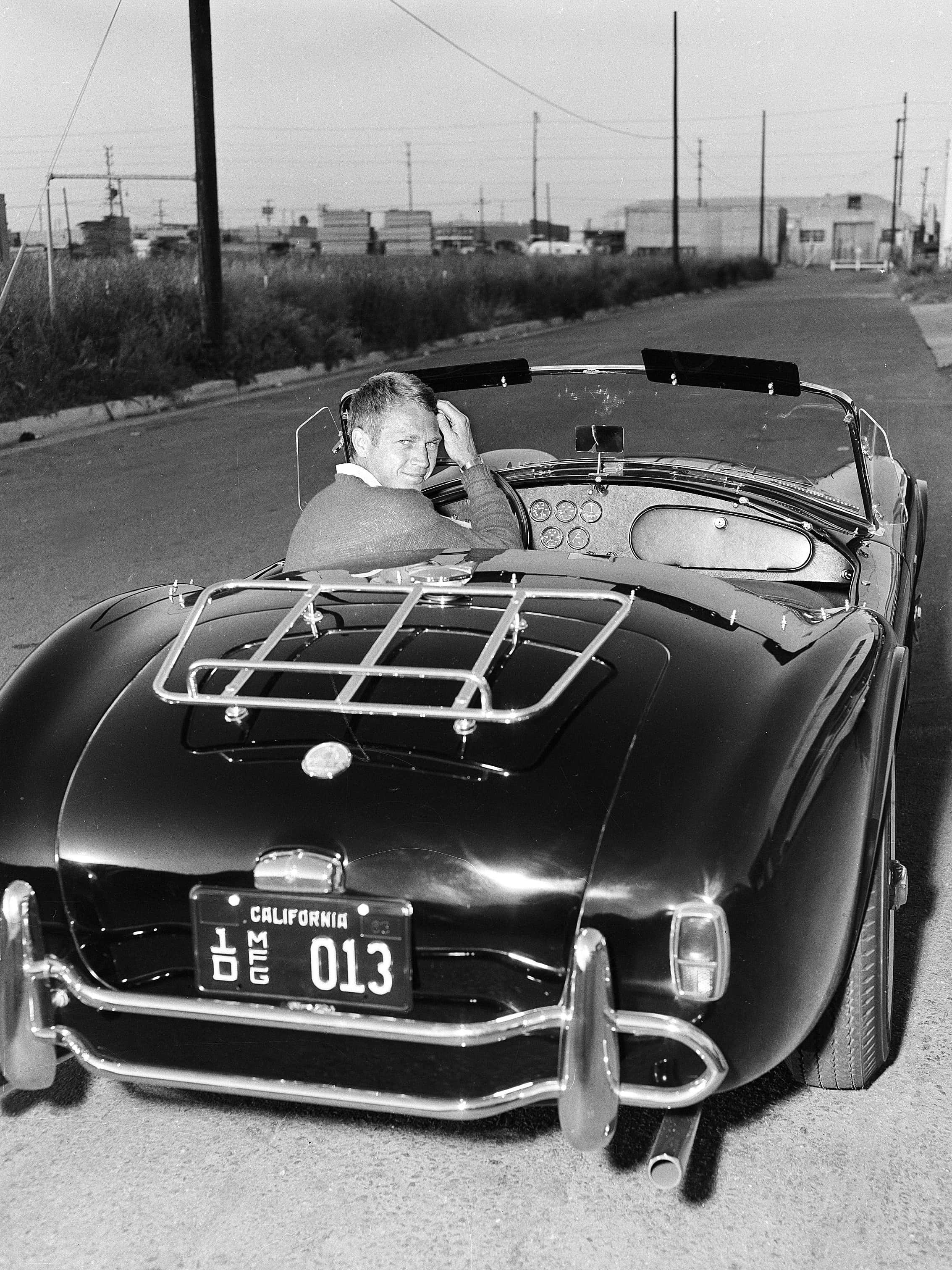 vintage black convertible, quiet roadside, bright daylight, 2K Phone Wallpaper