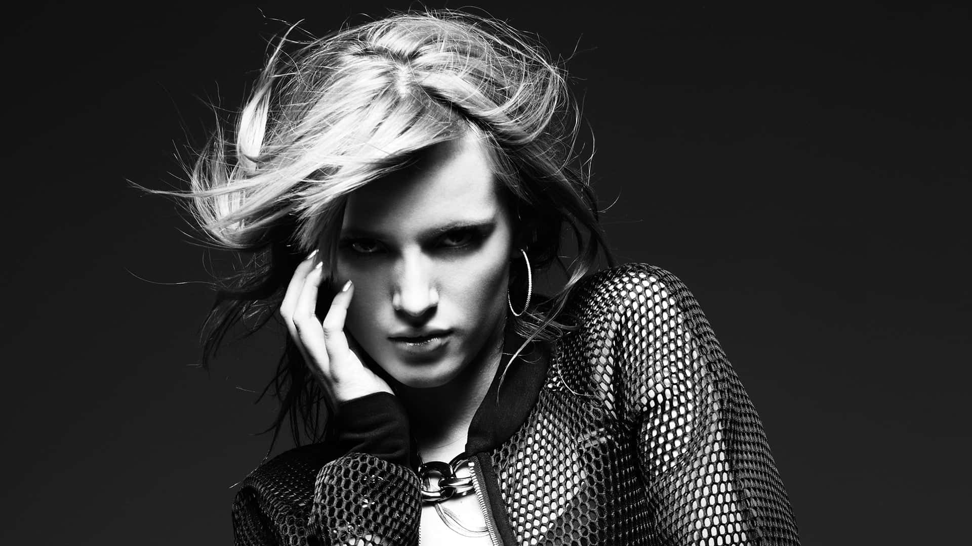 black and white portrait, woman with windswept blonde hair, intense gaze, Full HD Desktop Wallpaper