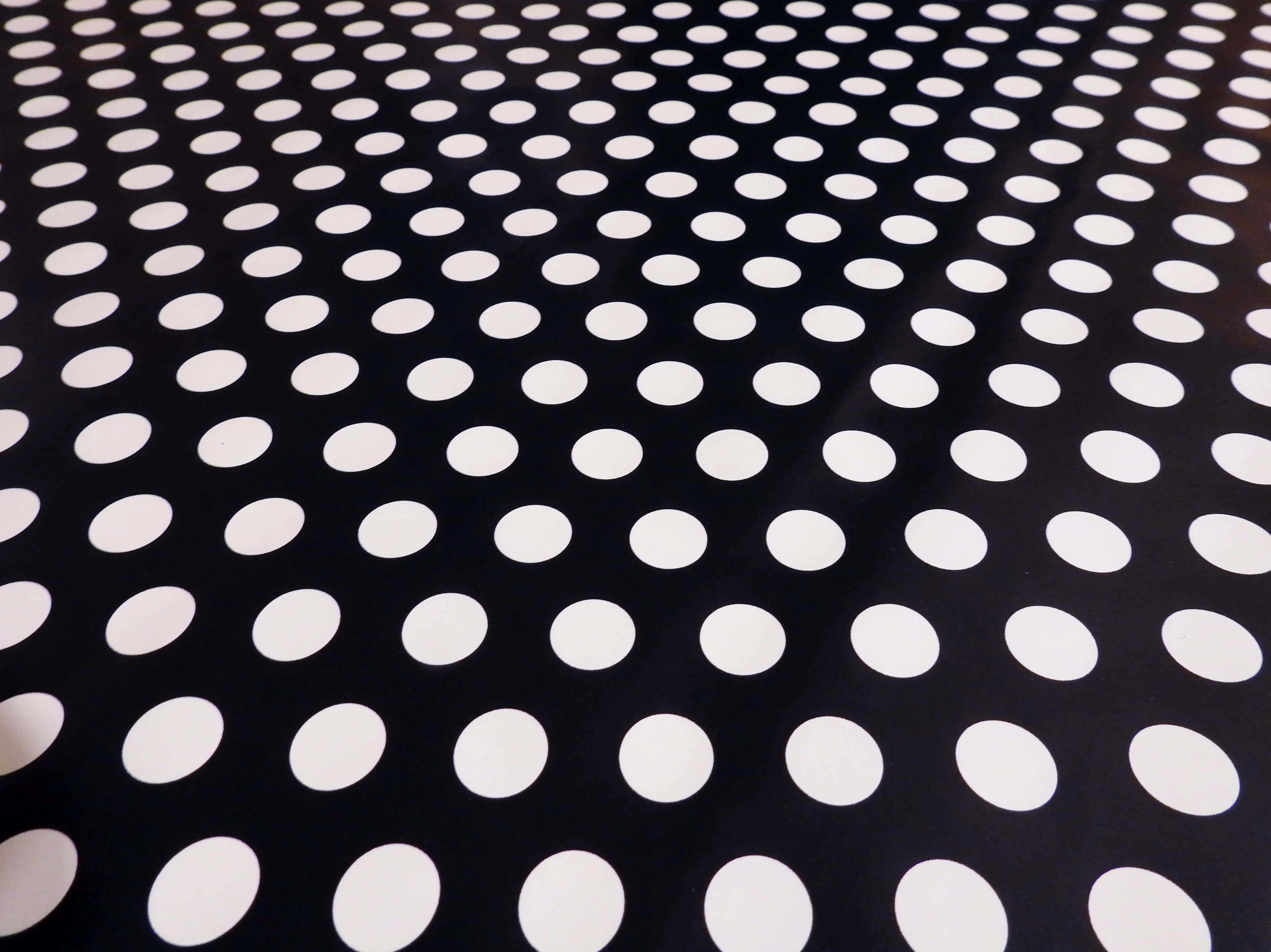 black fabric, evenly spaced white polka dots, bold geometric pattern, 4K Desktop Wallpaper