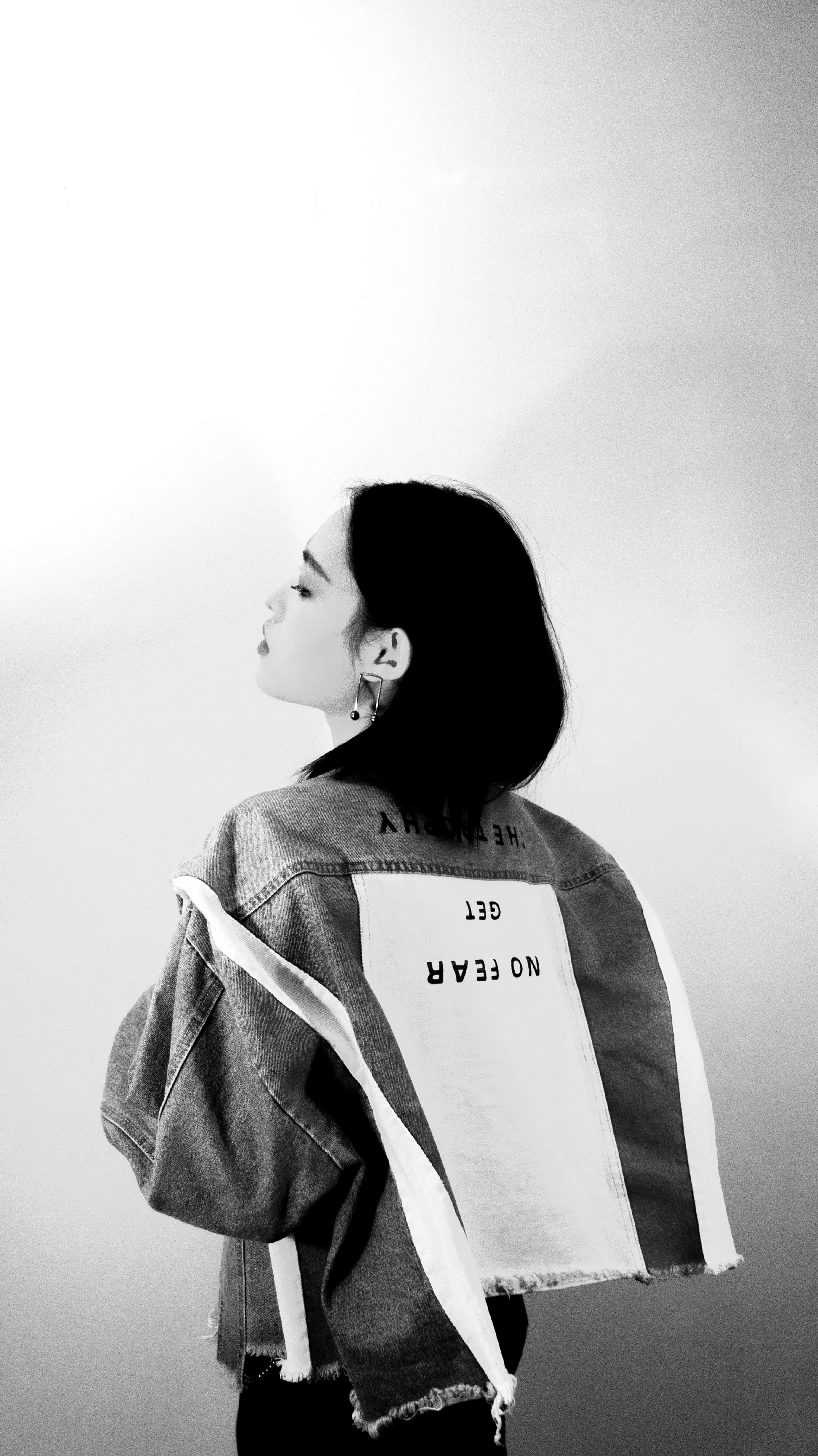 denim jacket, bold text on the back, young woman, 4K Phone Wallpaper