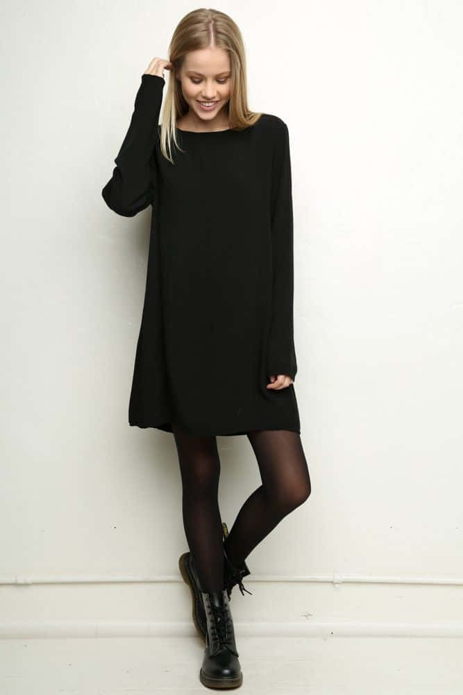 black long-sleeve dress, black boots, plain white wall, SD Phone Wallpaper
