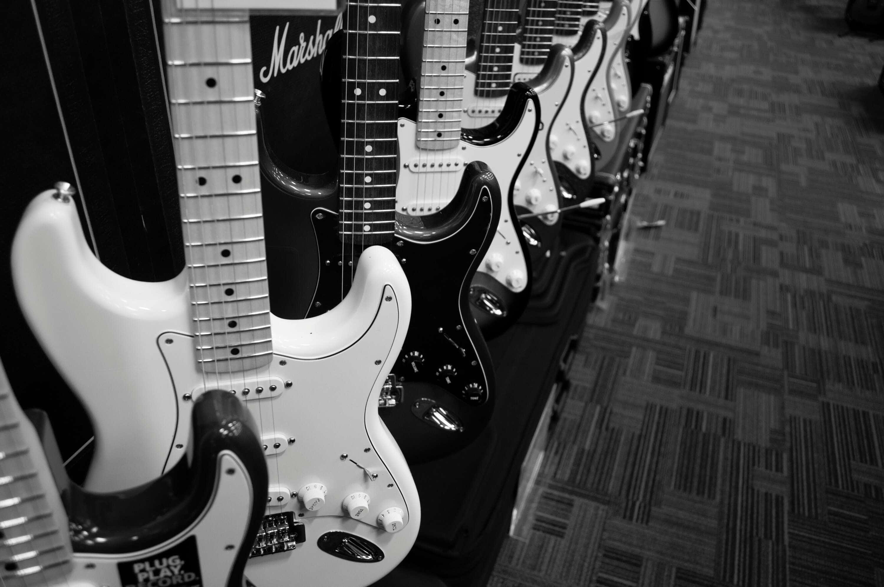 electric guitars, black and white, patterned carpet floor, 2K Desktop Wallpaper