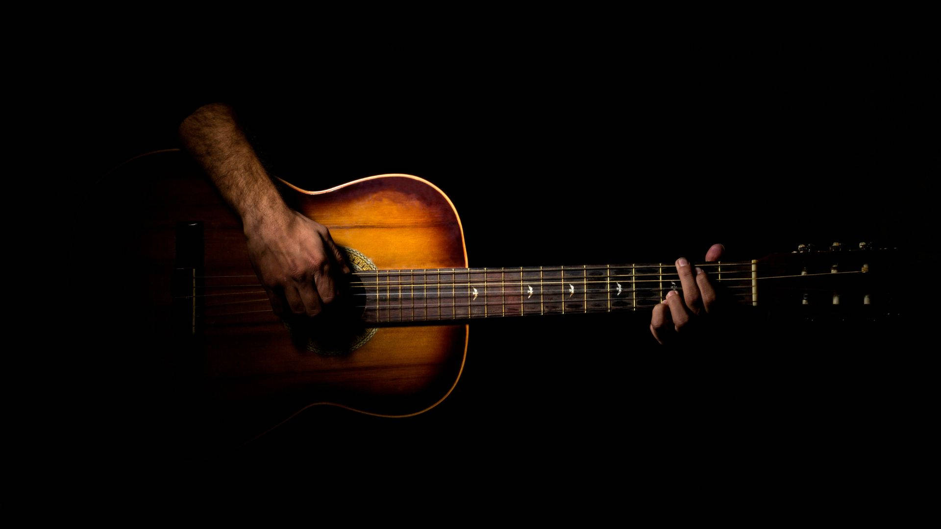 acoustic guitar, black background, dramatic spotlight, Full HD Desktop Wallpaper
