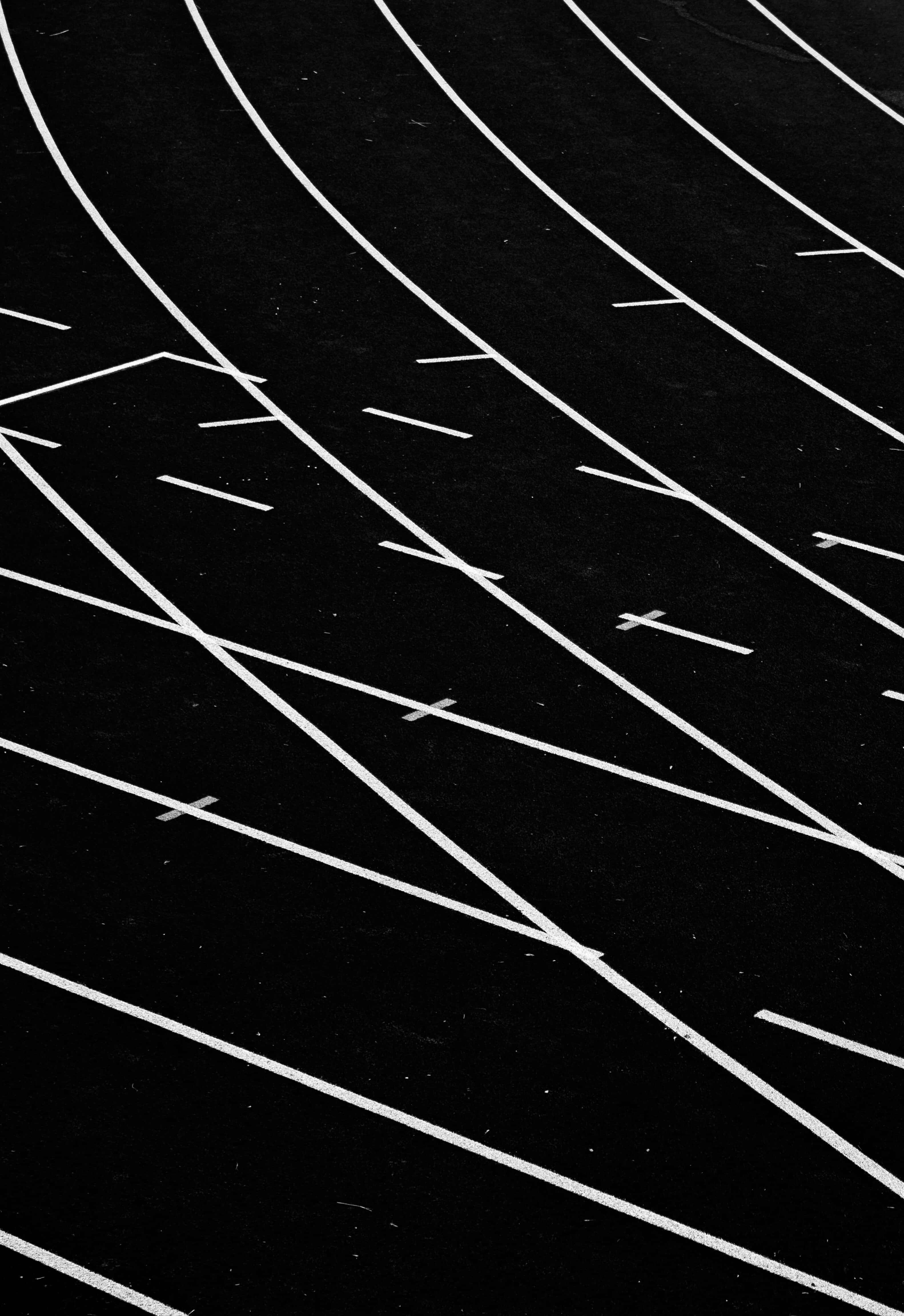 black athletic track, crisp white lane markings, starting blocks, 4K Phone Wallpaper