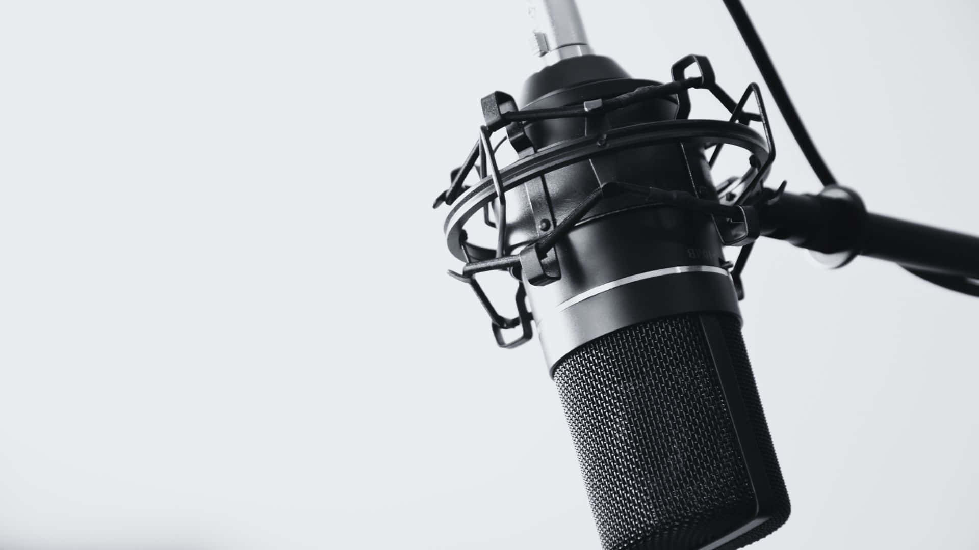 sleek black studio microphone, protective cage, minimalist white background, Full HD Desktop Wallpaper
