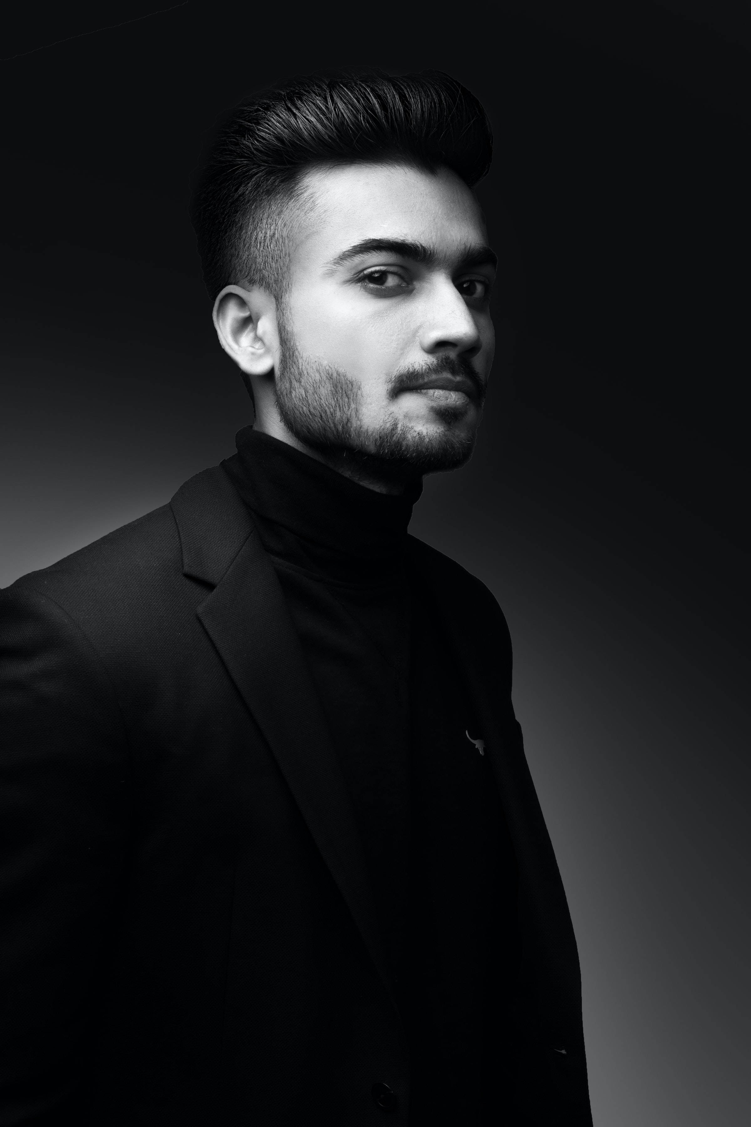 black turtleneck, blazer, high-contrast black and white studio portrait, 2K Phone Wallpaper