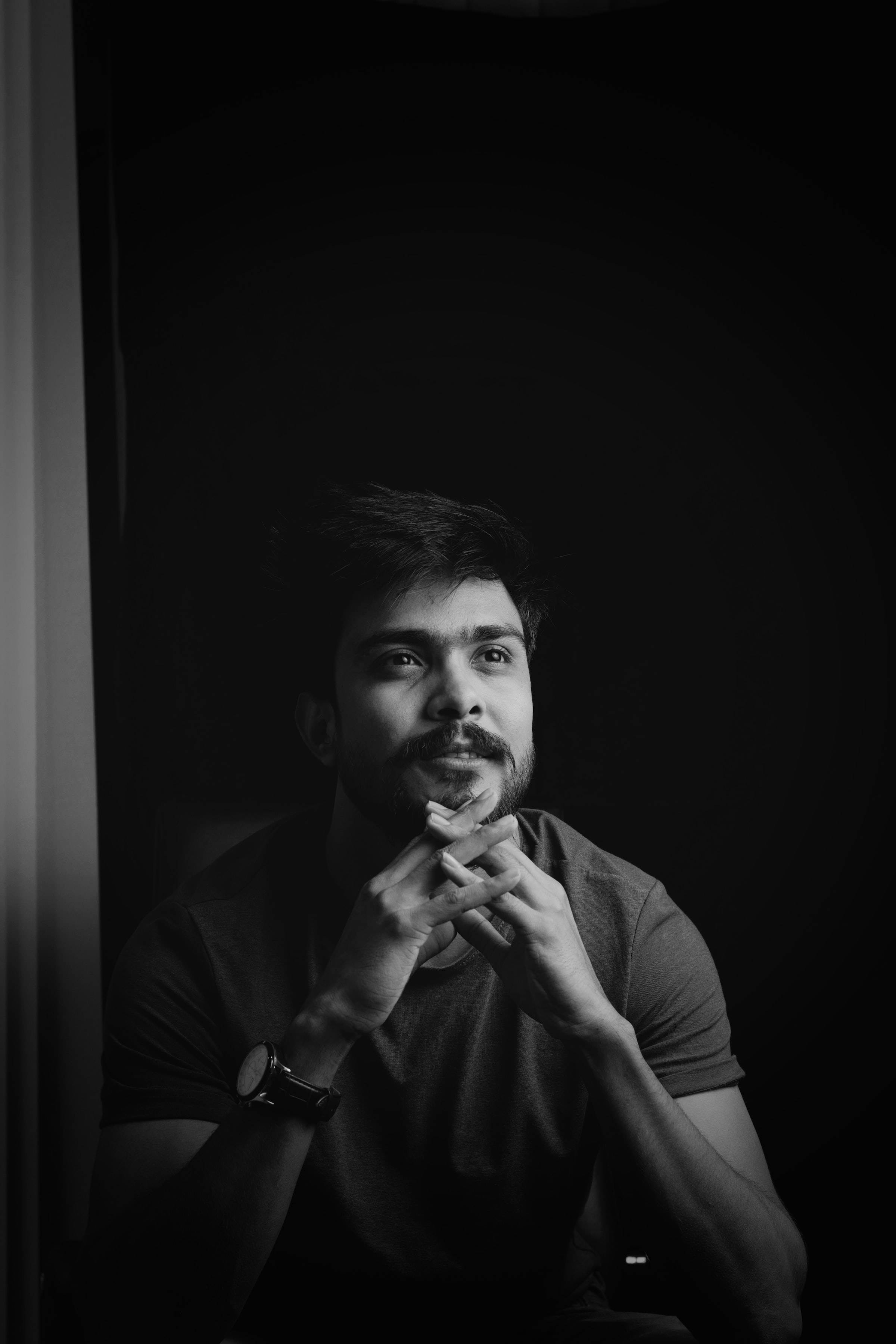 hands entwined, black and white portrait, contemplative man, 2K Phone Wallpaper