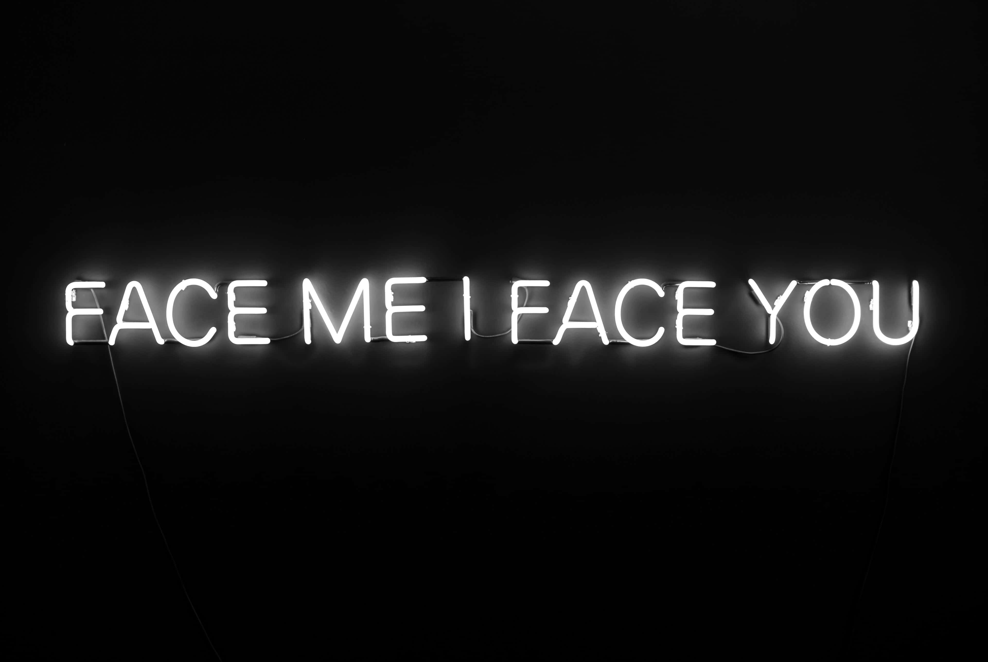 white neon sign, face me i face you, pitch black background, 4K Desktop Wallpaper