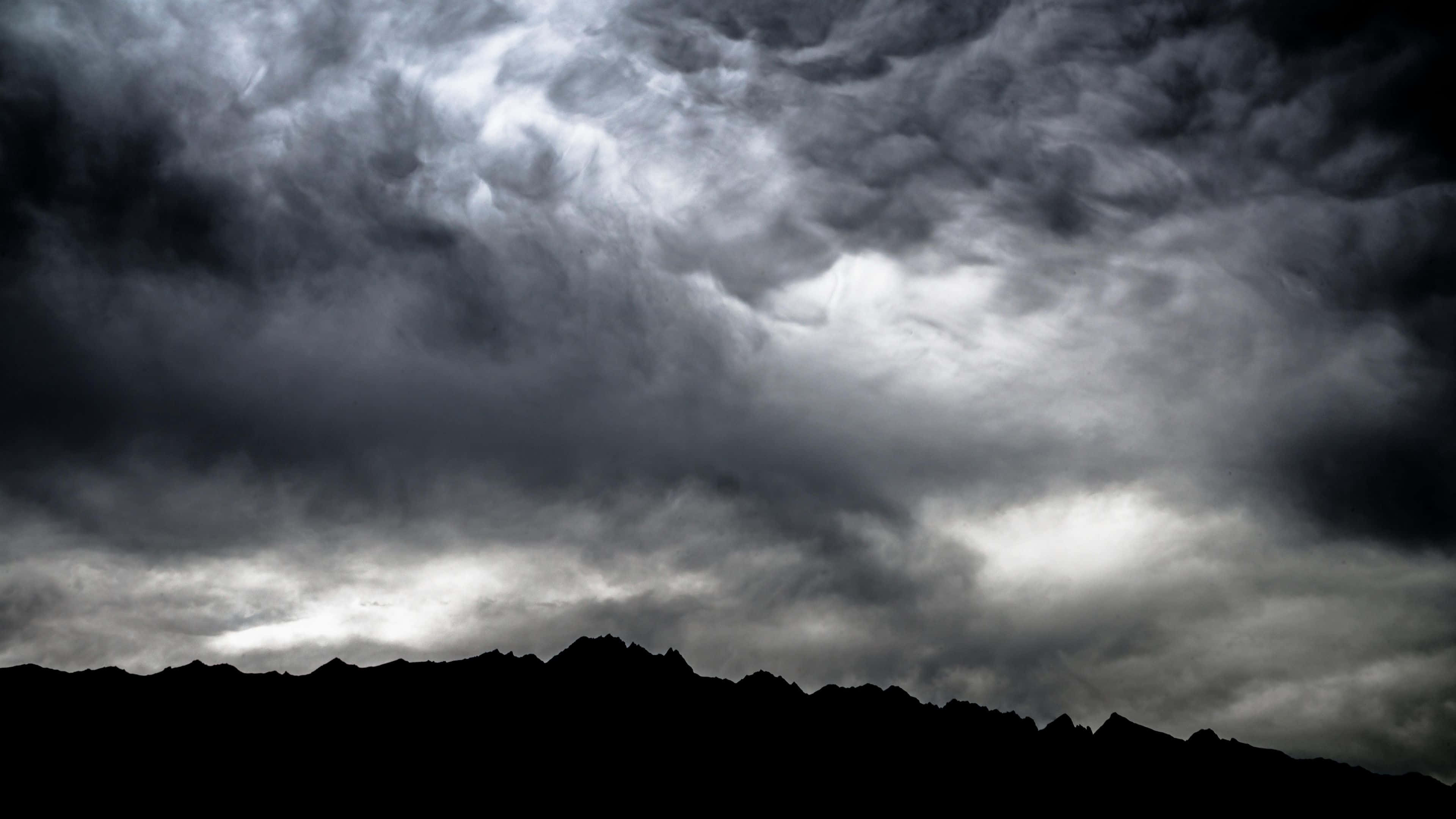 Dark Storm, black mountain silhouette, moody twilight light, 4K Desktop Wallpaper