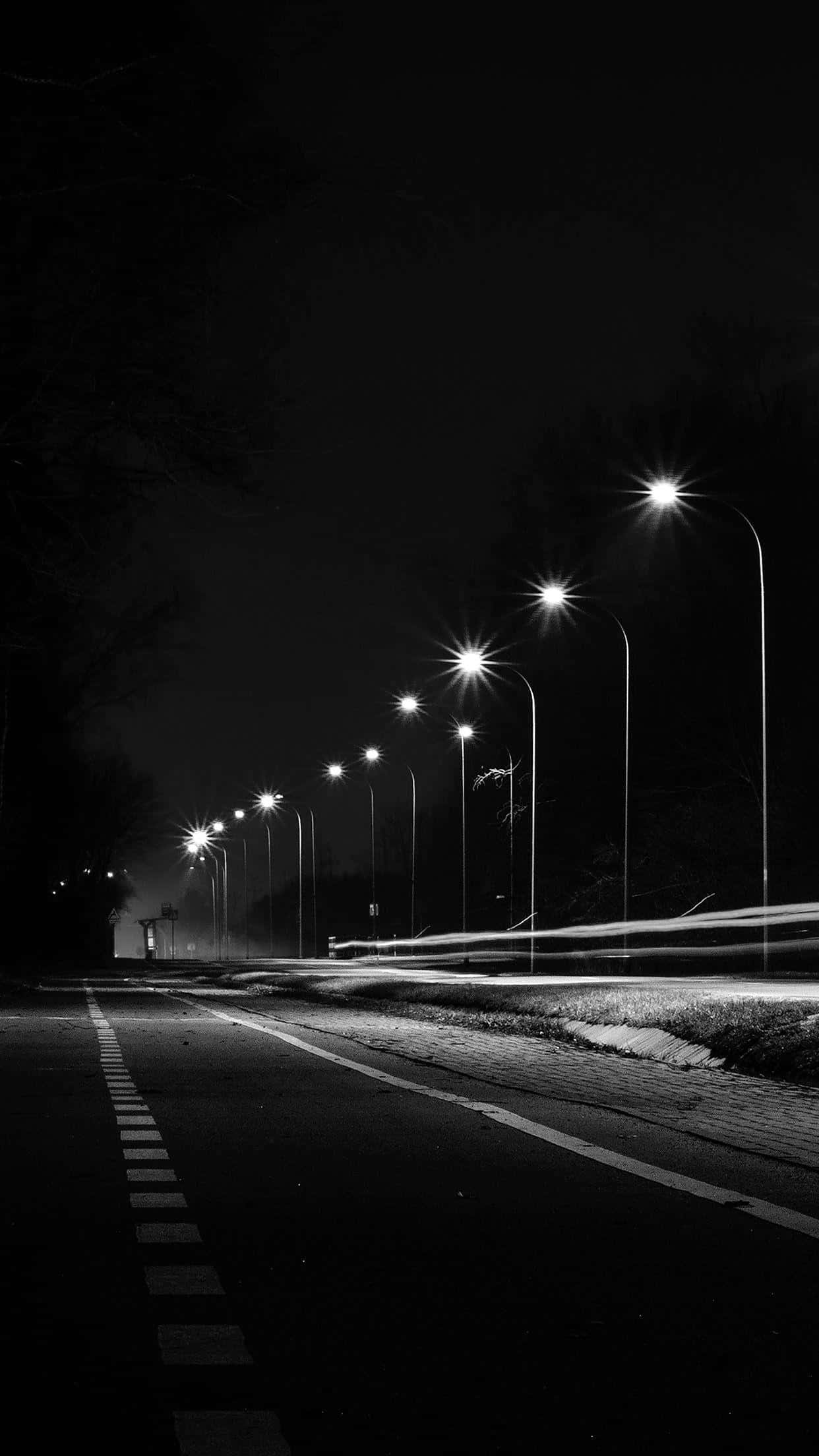 black and white night scene, city street, road lined with streetlights, Full HD Phone Wallpaper