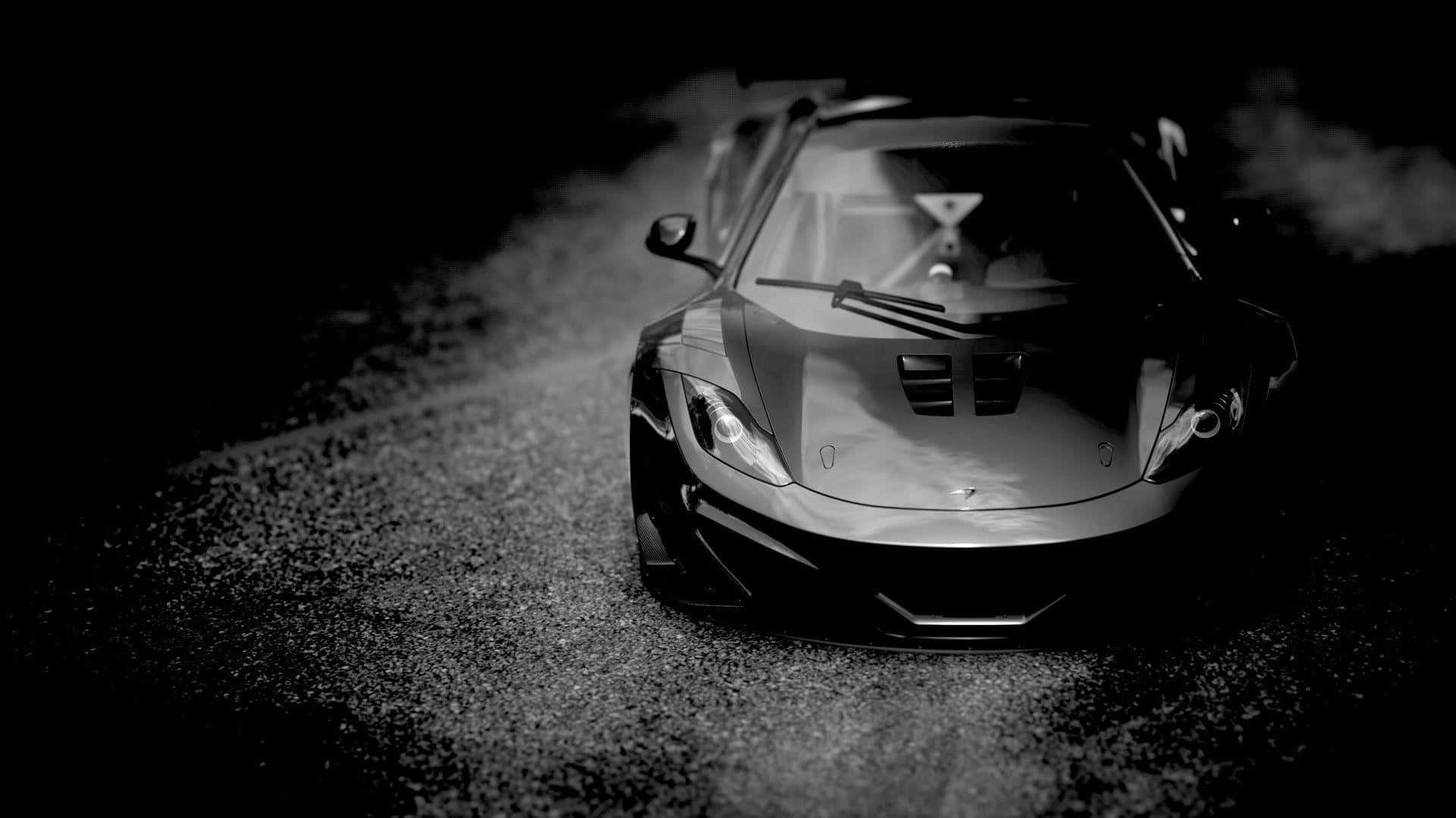 black sports car, glowing headlights, gravel road, Full HD Desktop Wallpaper