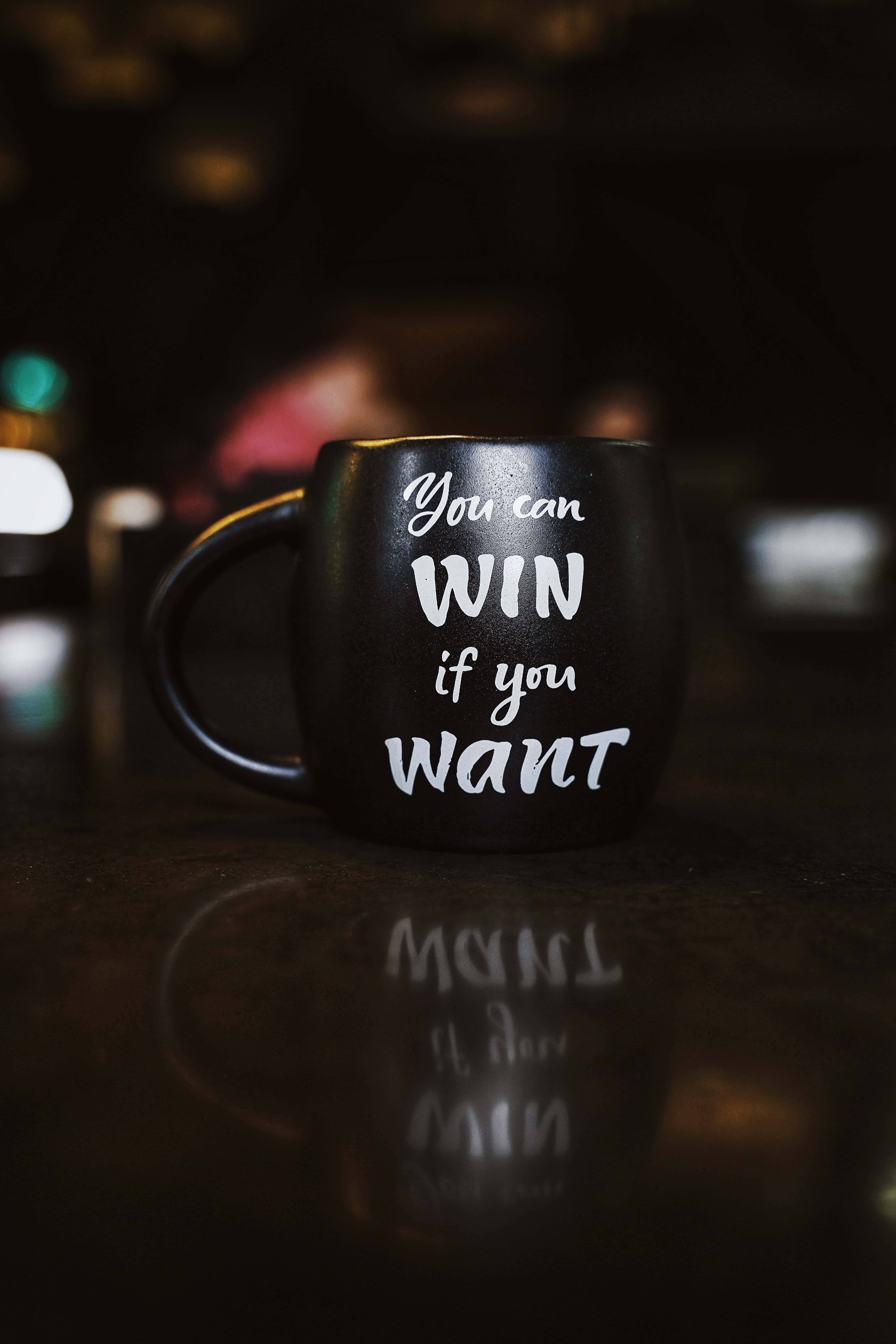 black coffee mug, white motivational text, reflective surface, 5K Phone Wallpaper
