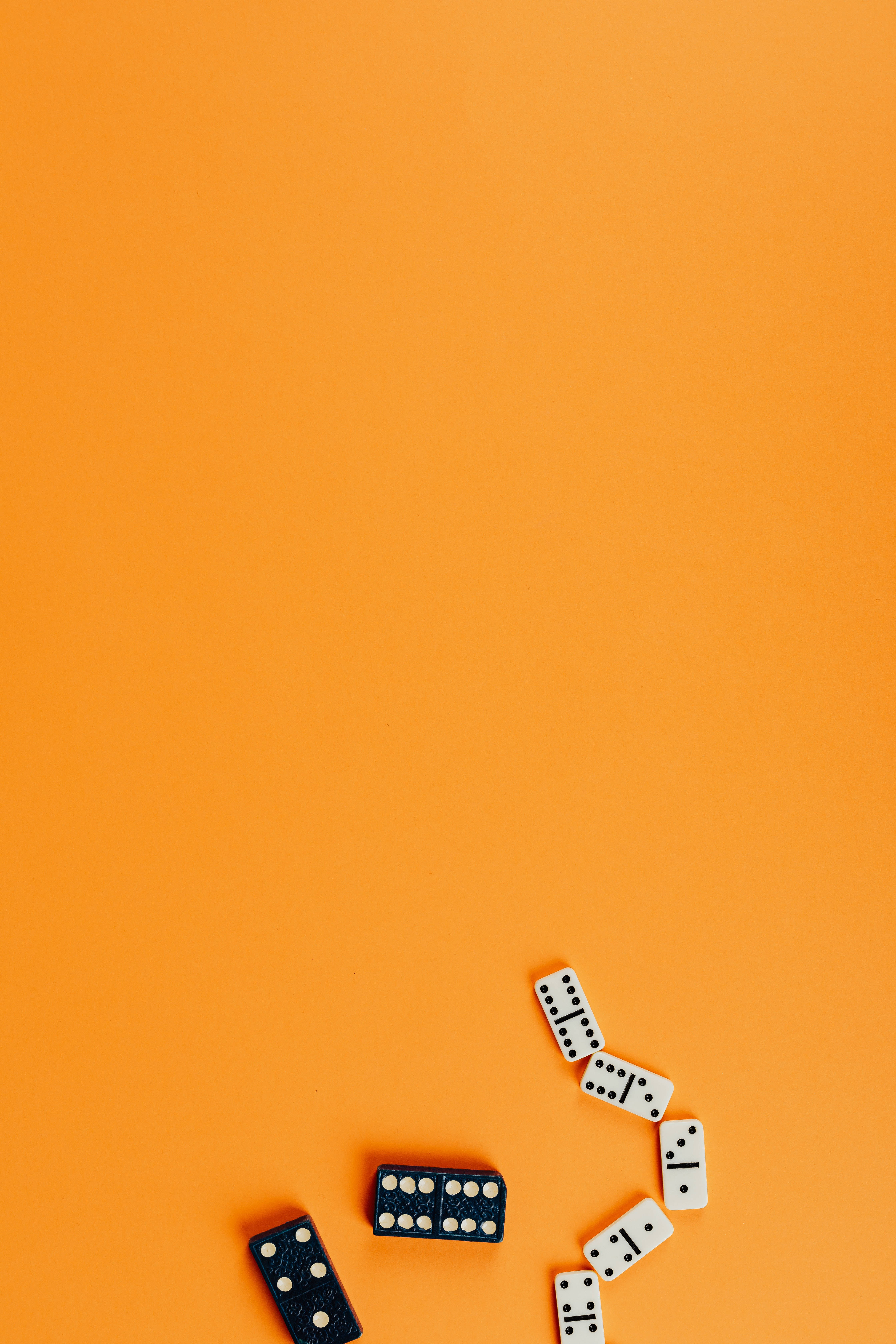 Black Dot iPhone, black and white dominoes, vibrant orange background, 5K Phone Wallpaper