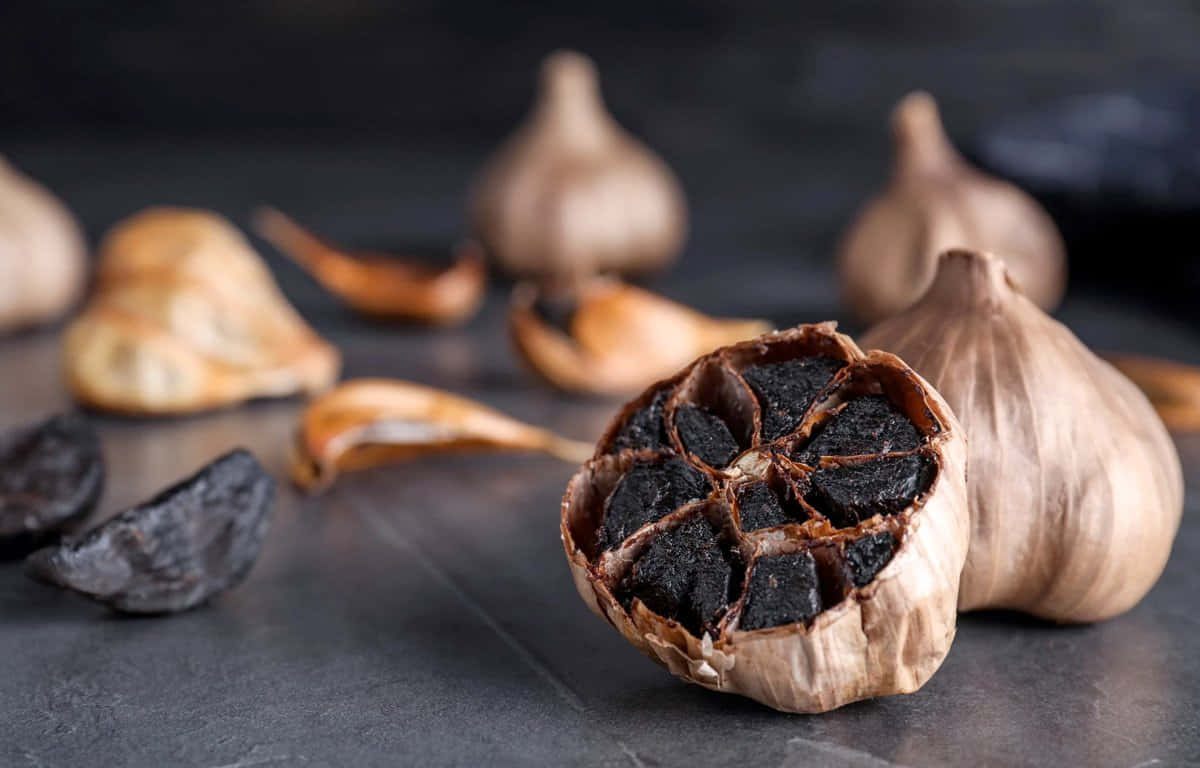 black garlic, slate surface, halved black garlic bulb, SD Desktop Wallpaper