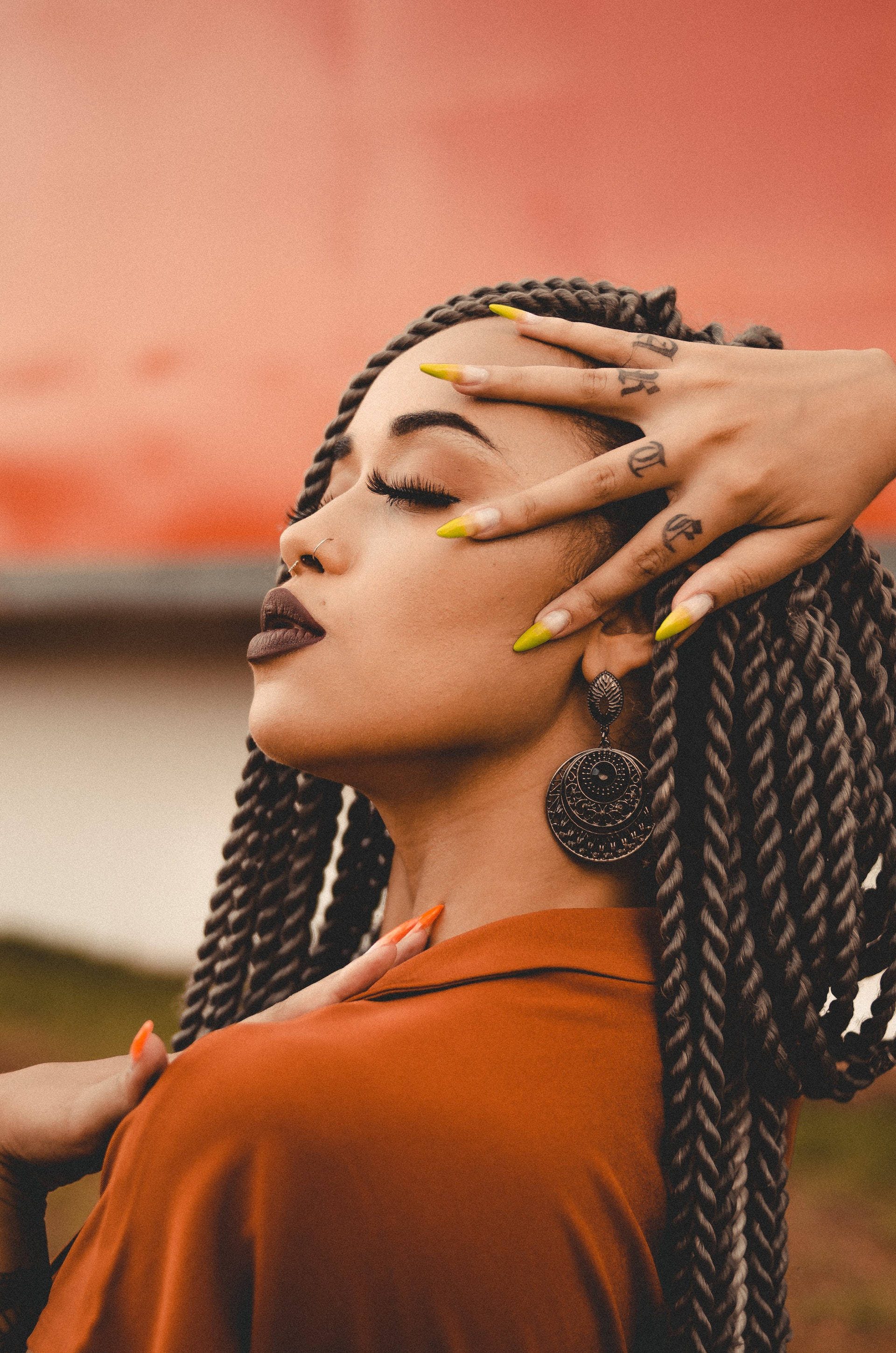 crochet hairstyle, yellow nails, warm orange backdrop, 2K Phone Wallpaper