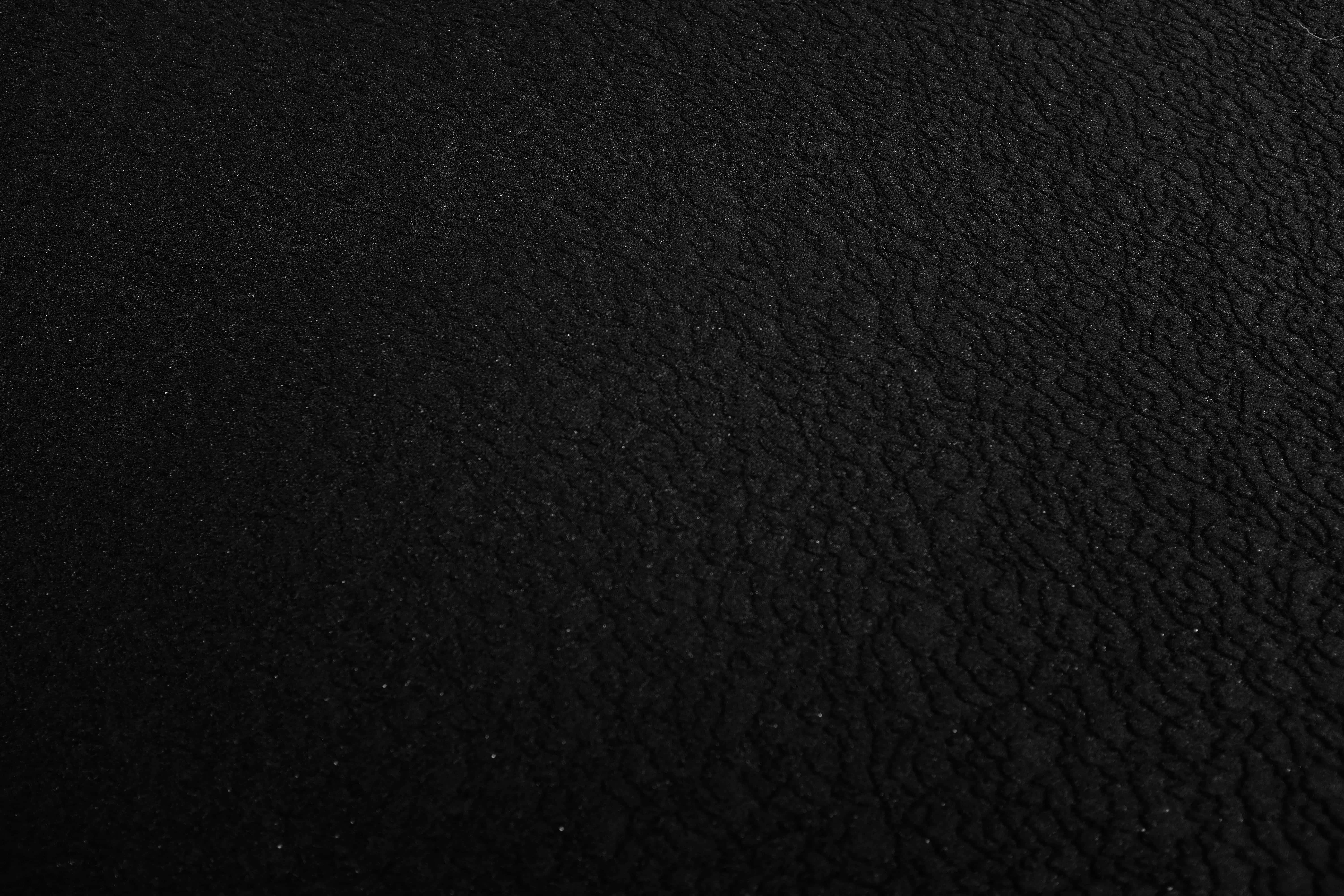 black gradient, black leather surface, subtle grain texture, 5K Desktop Wallpaper