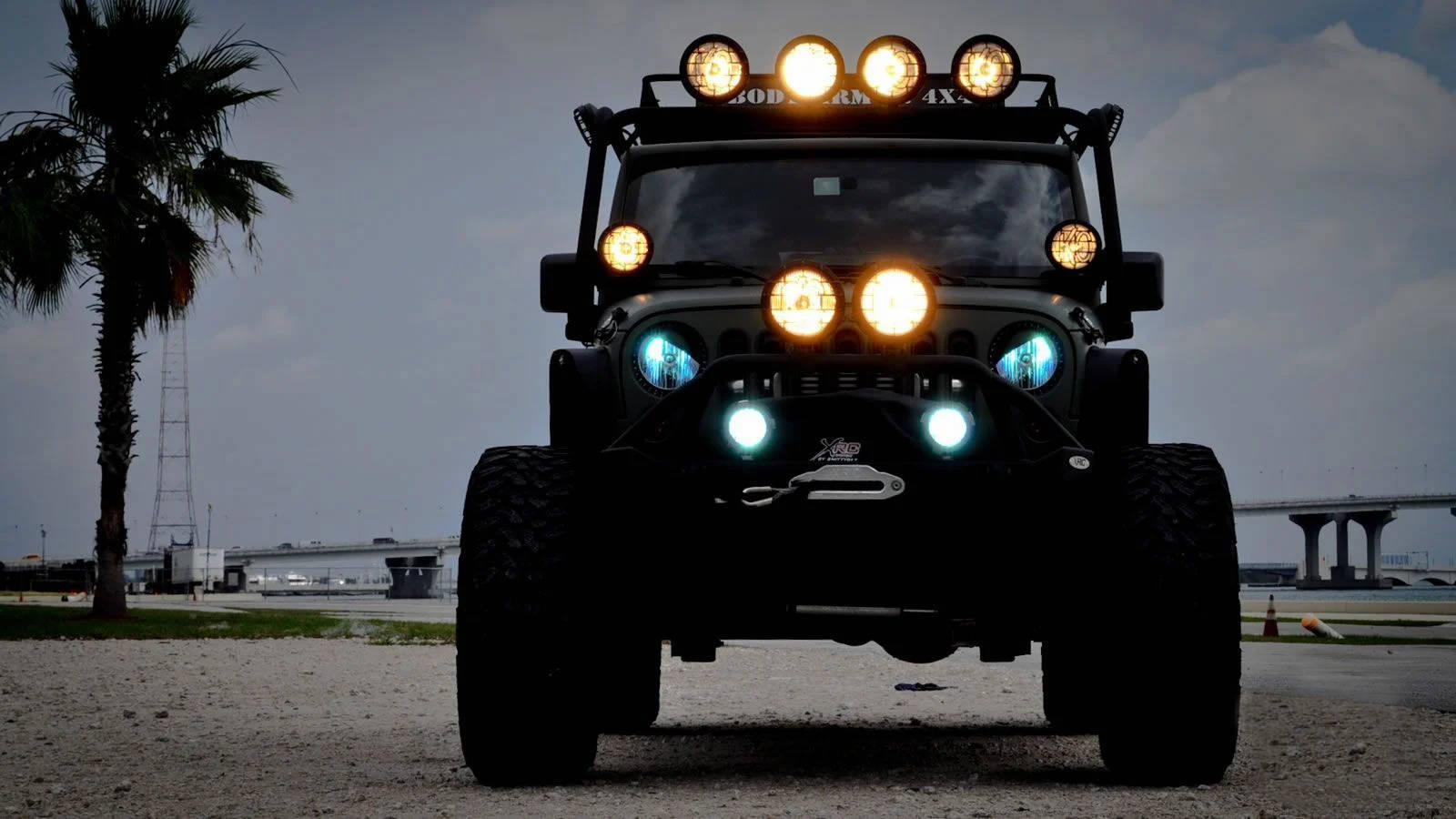 Black Jeep, glowing amber and blue lights, sandy coastal scene, HD Desktop Wallpaper