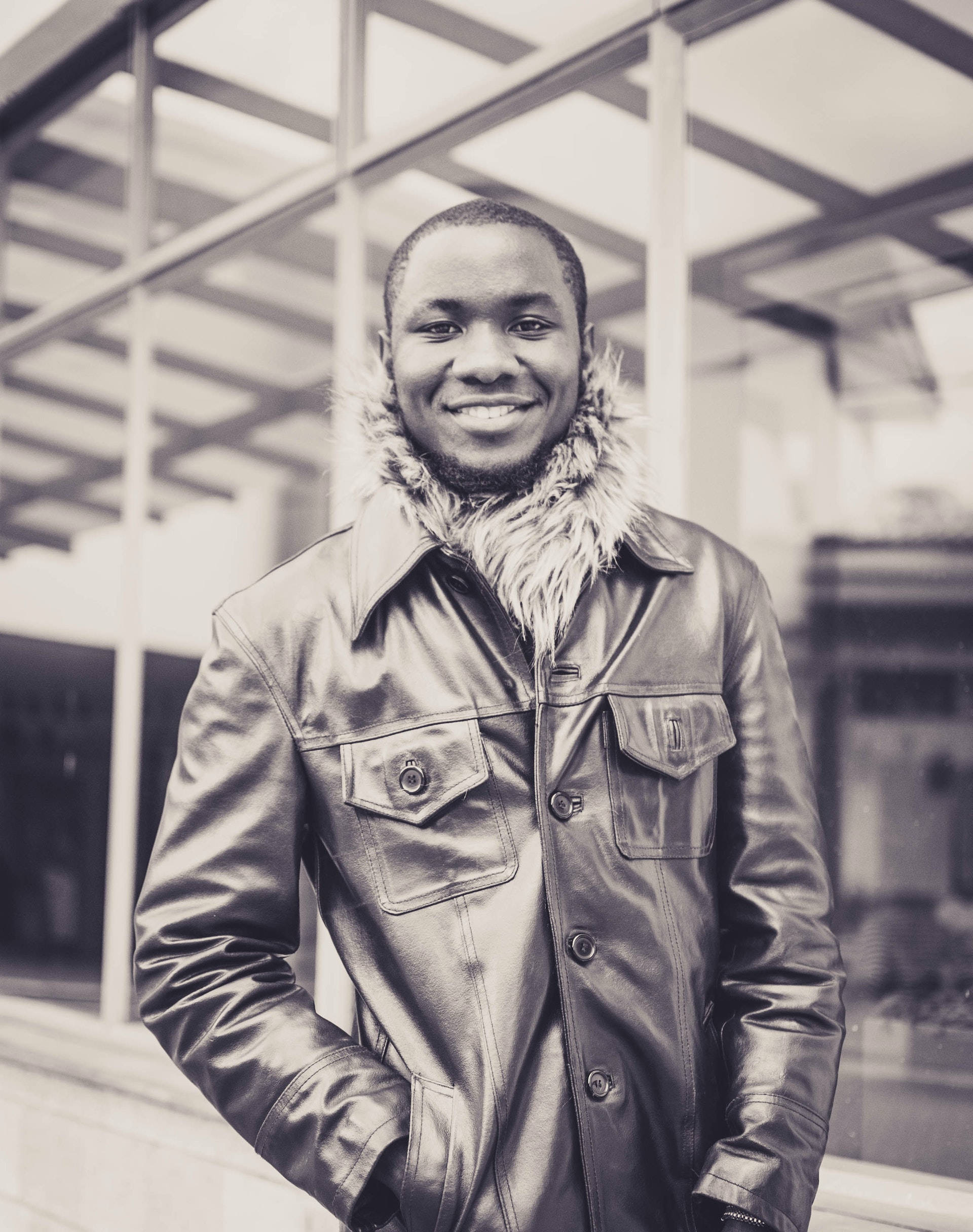 sepia tone, fur-lined leather jacket, modern glass building, Full HD Phone Wallpaper