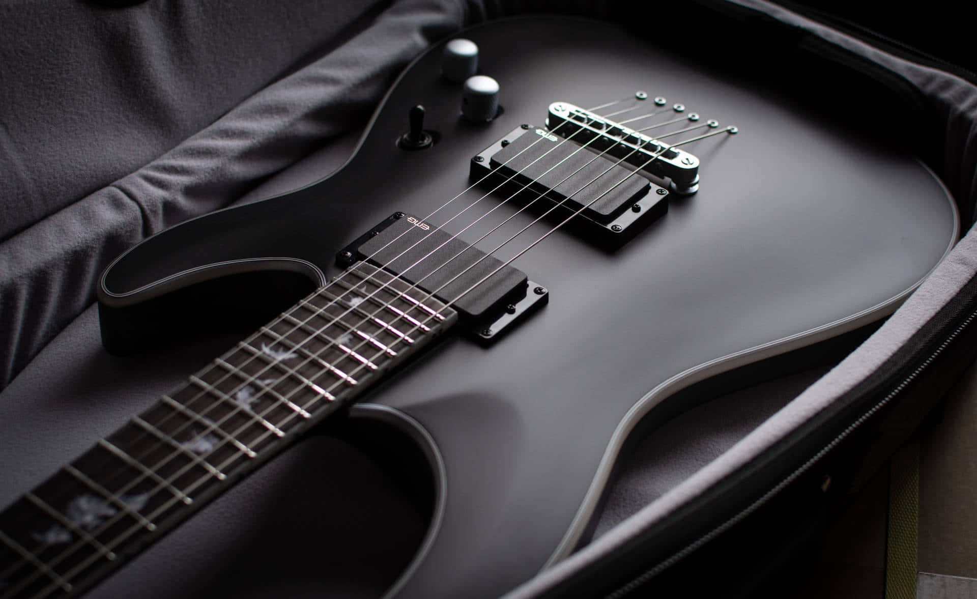 matte black electric guitar, dark padded case, soft lighting, Full HD Desktop Wallpaper