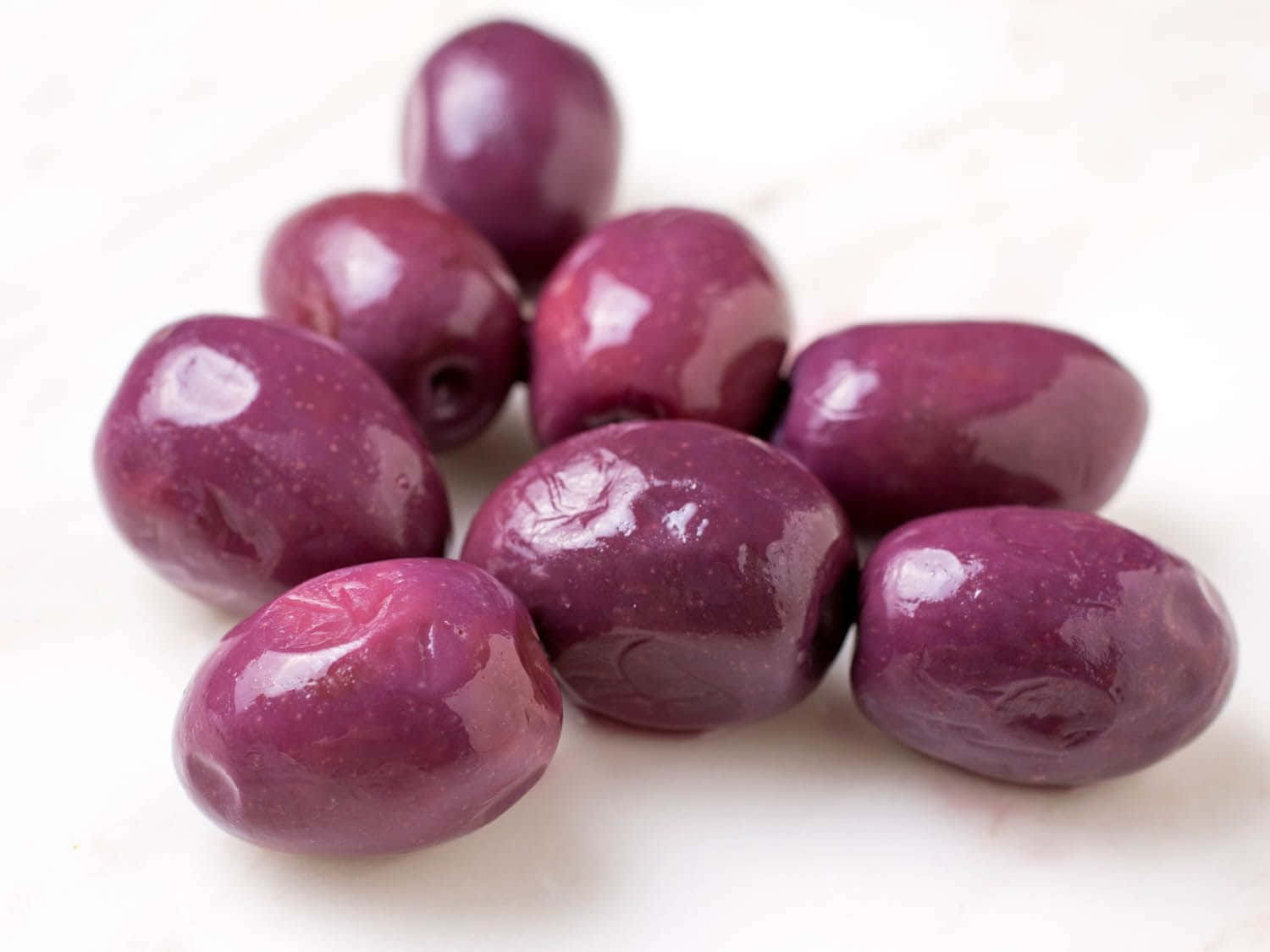 Black Olives, glossy purple olives, bright white surface, HD Desktop Wallpaper