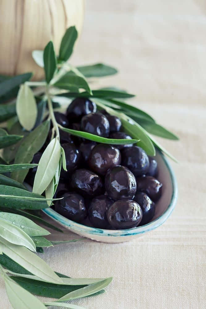 black olives, glossy black olives, fresh green olive leaves, SD Phone Wallpaper
