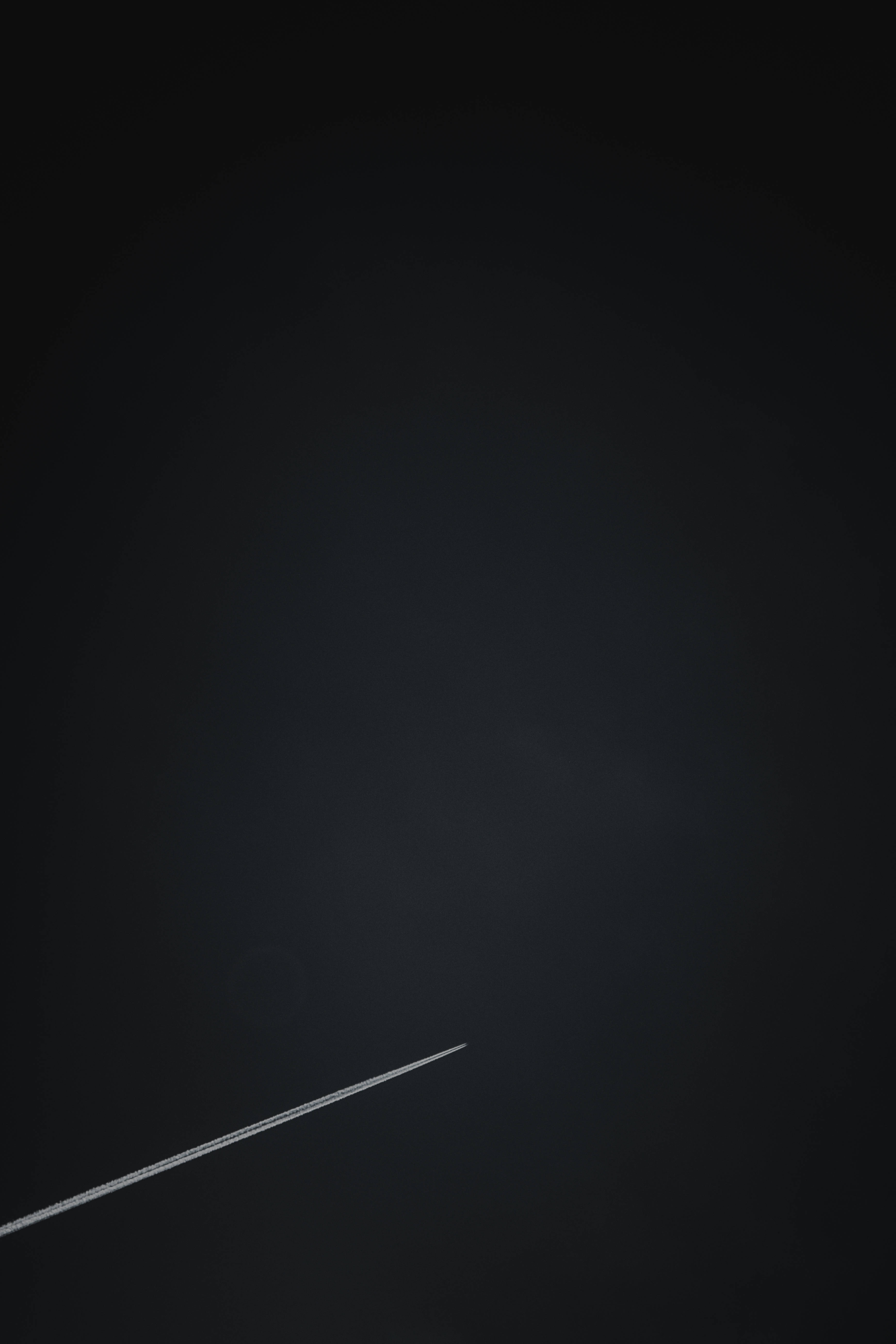 black page, bright white contrail, deep gradient black sky, 5K Phone Wallpaper