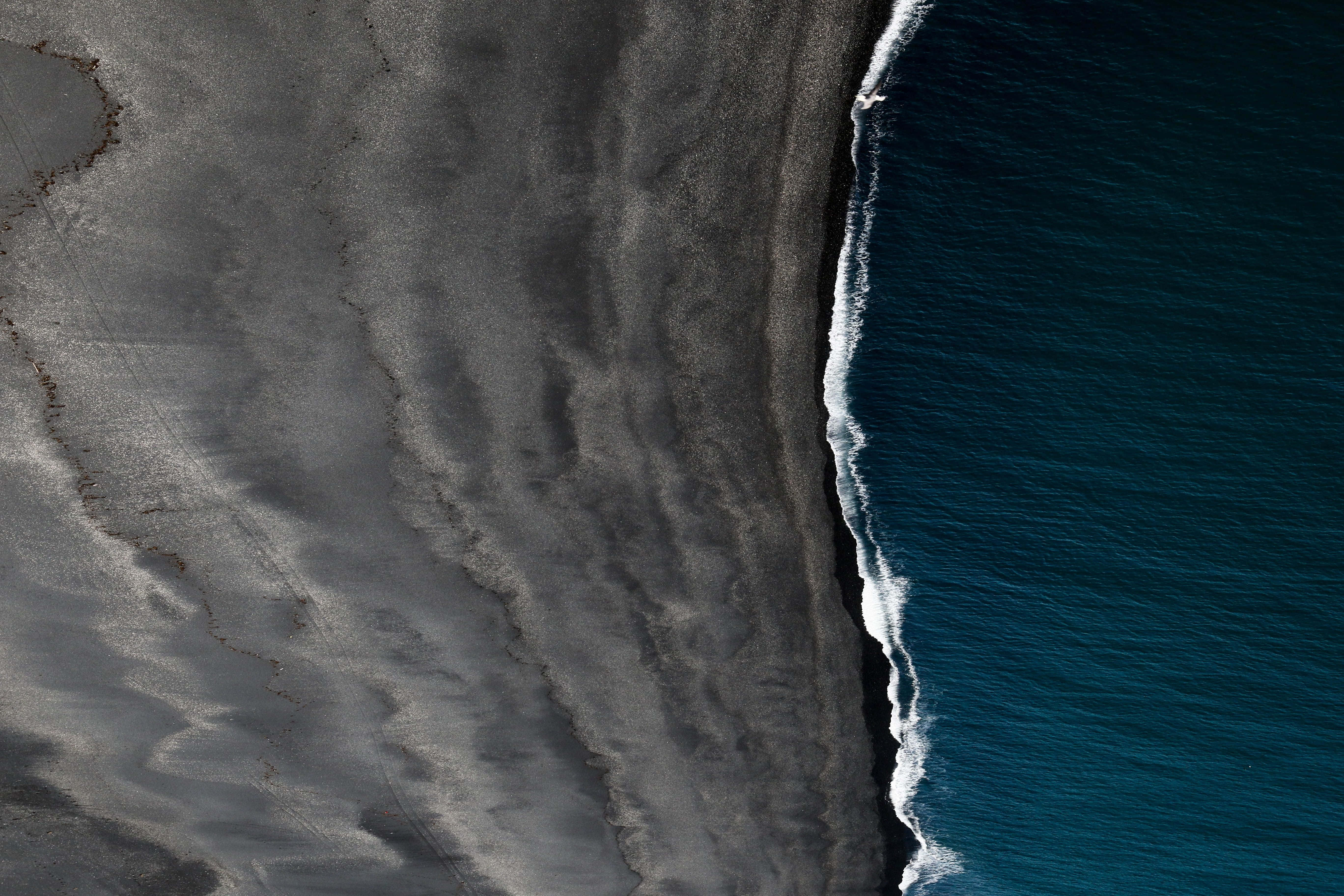 black sand beach, aerial view, deep blue ocean, 5K Desktop Wallpaper