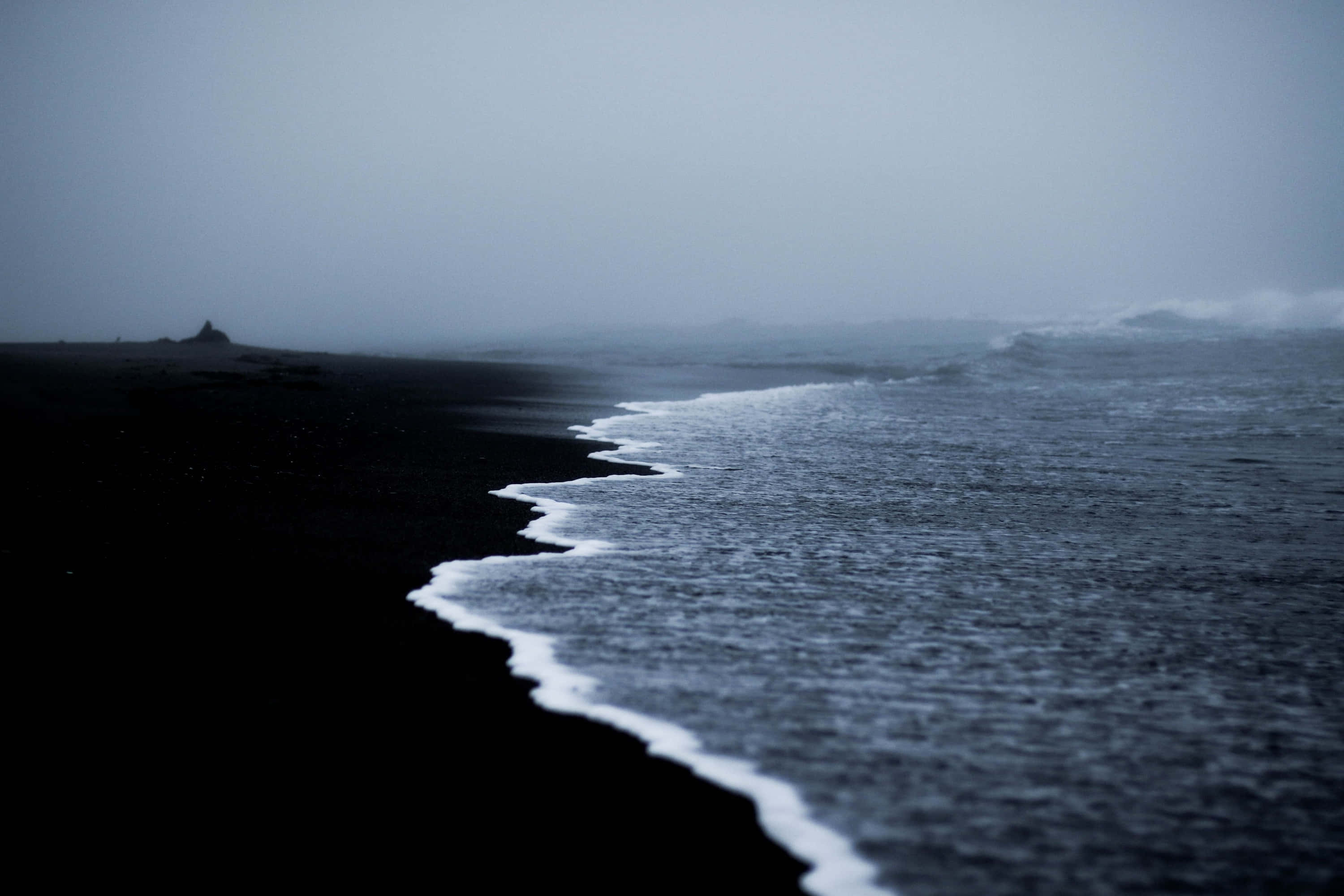 black sand beach, dark volcanic sand, frothy waves, 2K Desktop Wallpaper