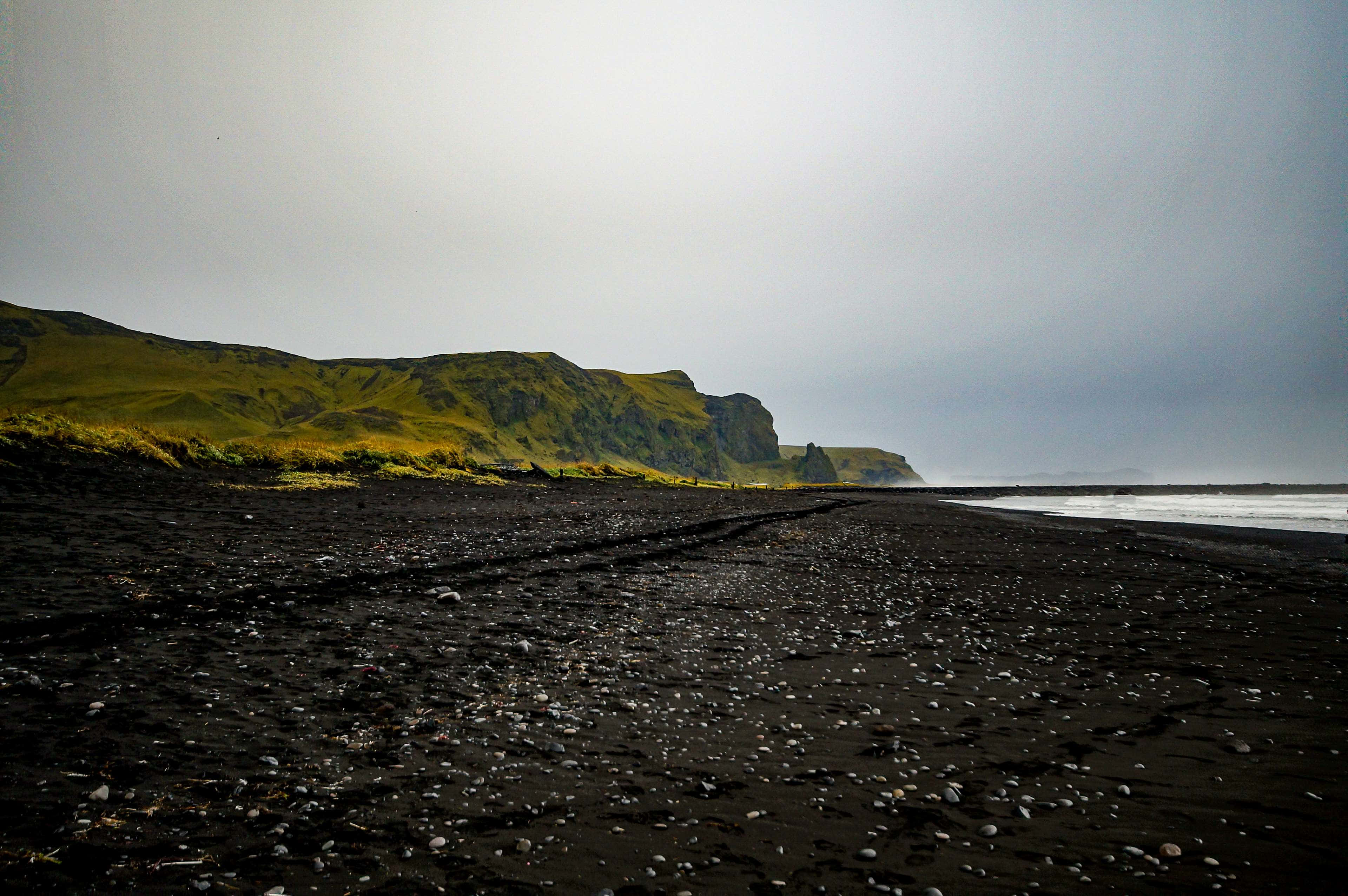 black sand beach, volcanic beach, mossy green cliff, 4K Desktop Wallpaper