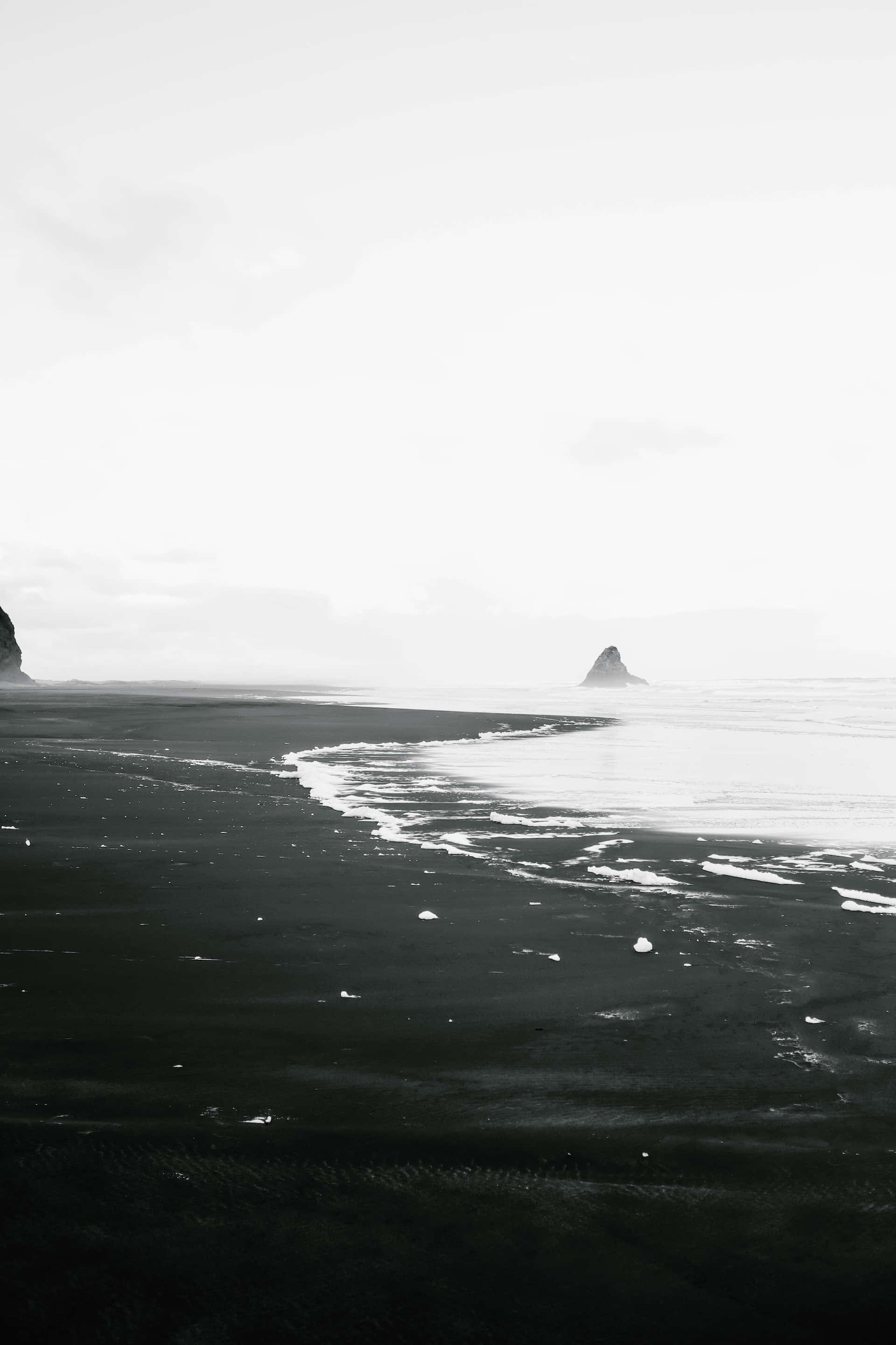 black sand beach, calm ocean waves, hazy overcast sky, 2K Phone Wallpaper