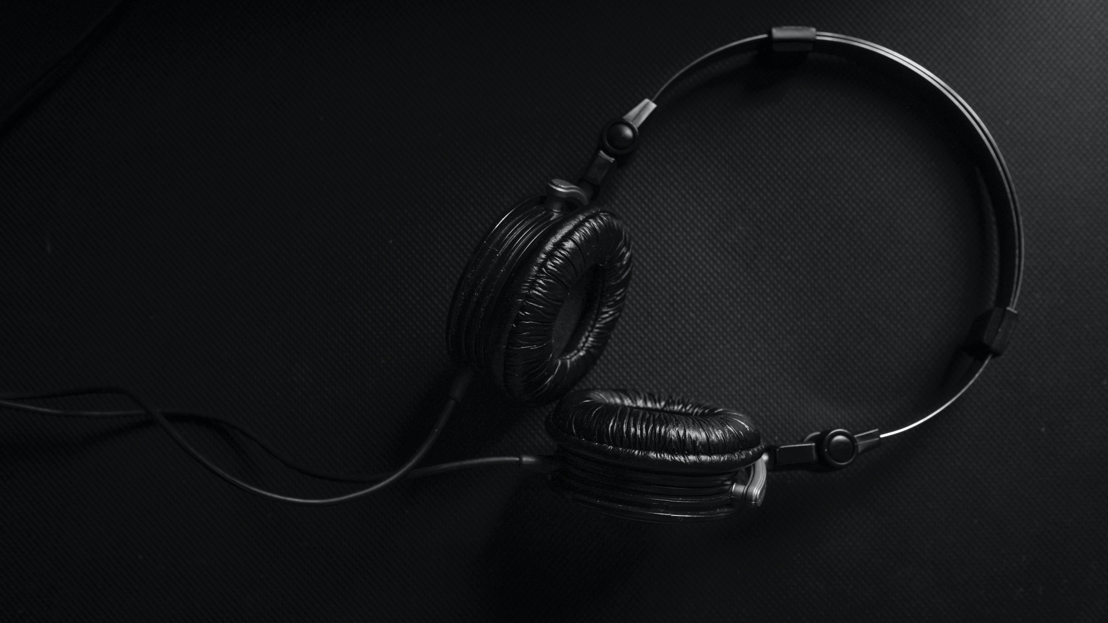Black Screen 4K, over-ear headphones, textured dark surface, 4K Desktop Wallpaper