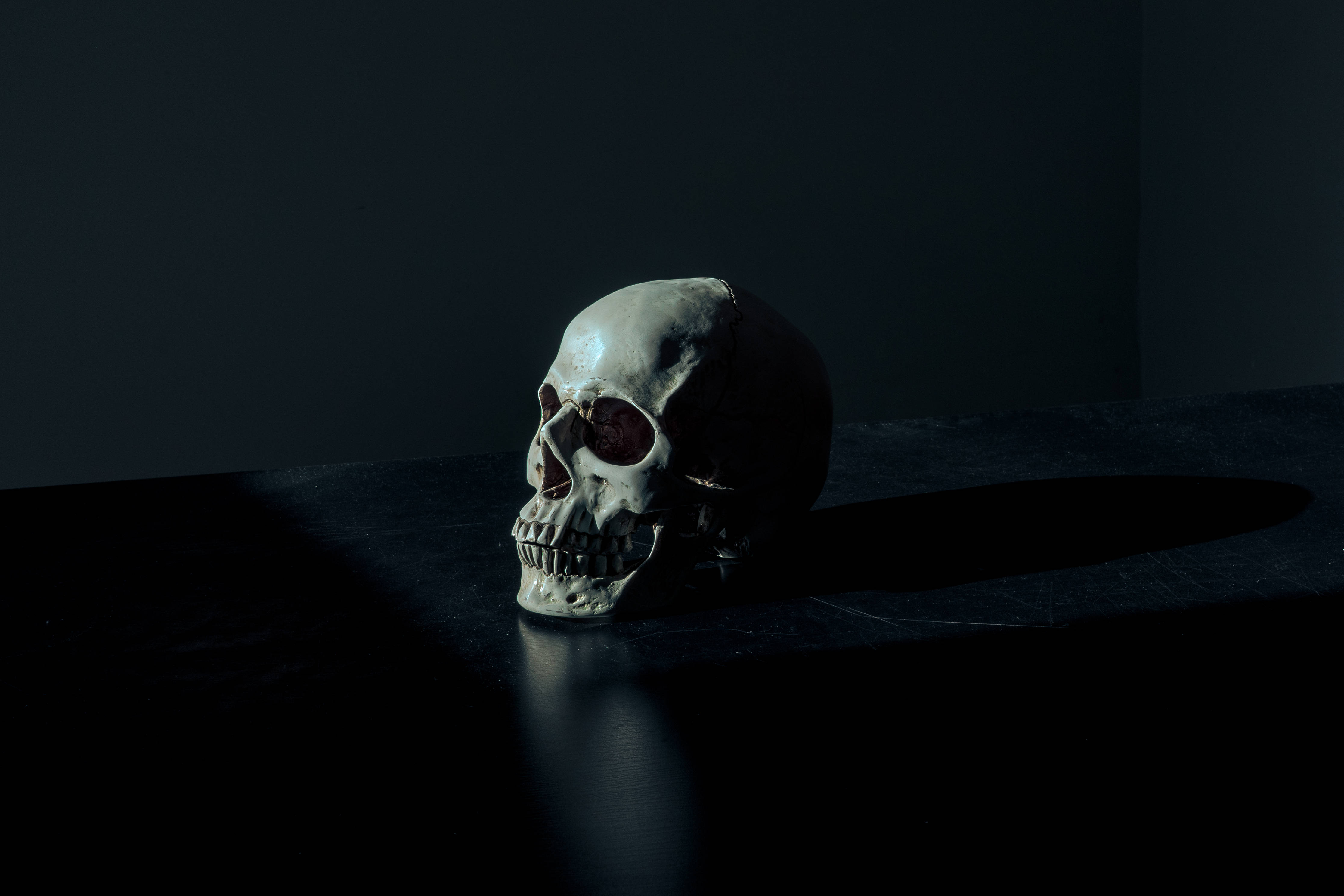 Paranormal Dark Anime Skull, dramatic spotlight, dark surface, 4K Desktop Wallpaper