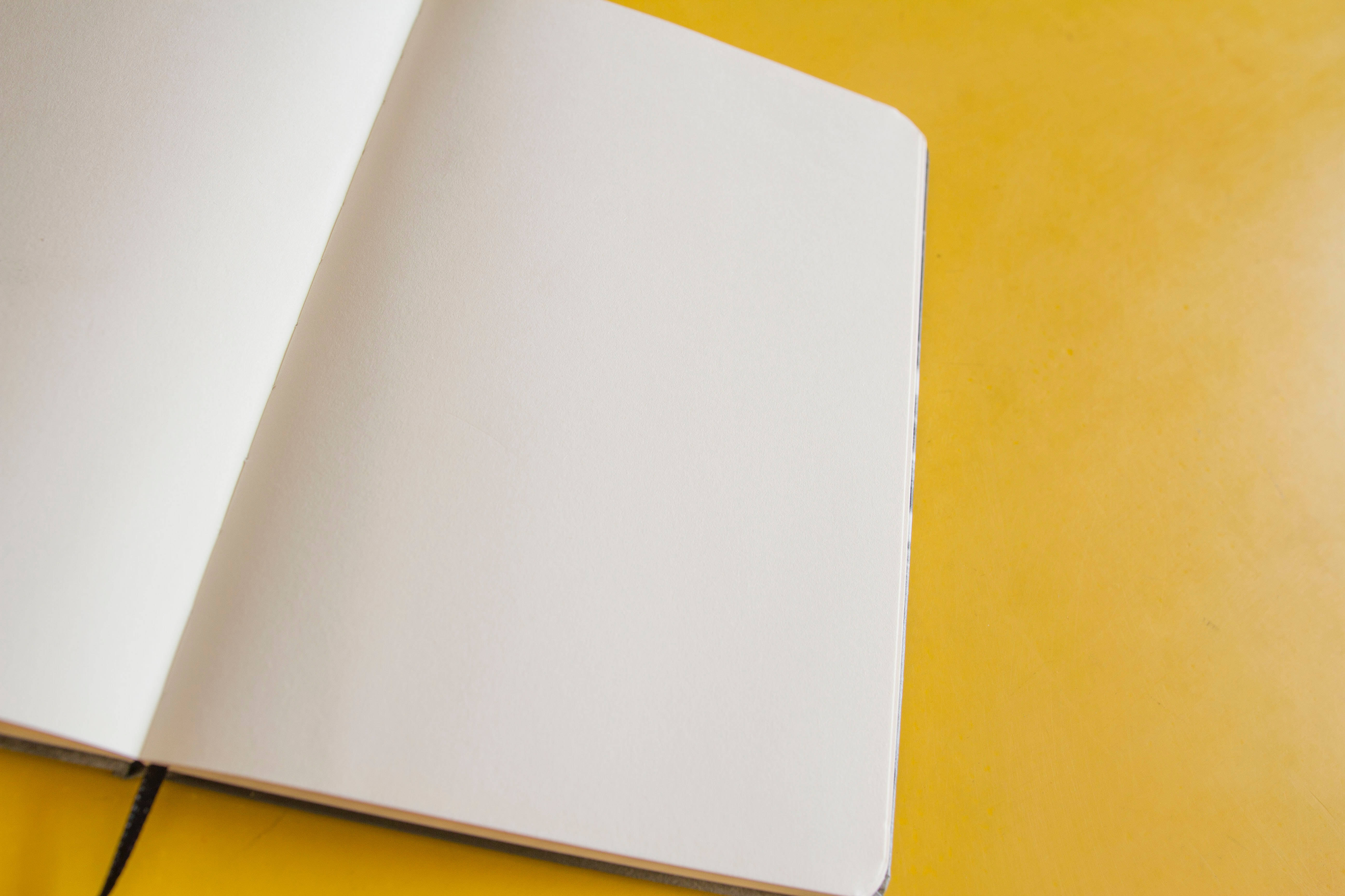 plain white blank page, blank notebook, vibrant yellow surface, 5K Desktop Wallpaper