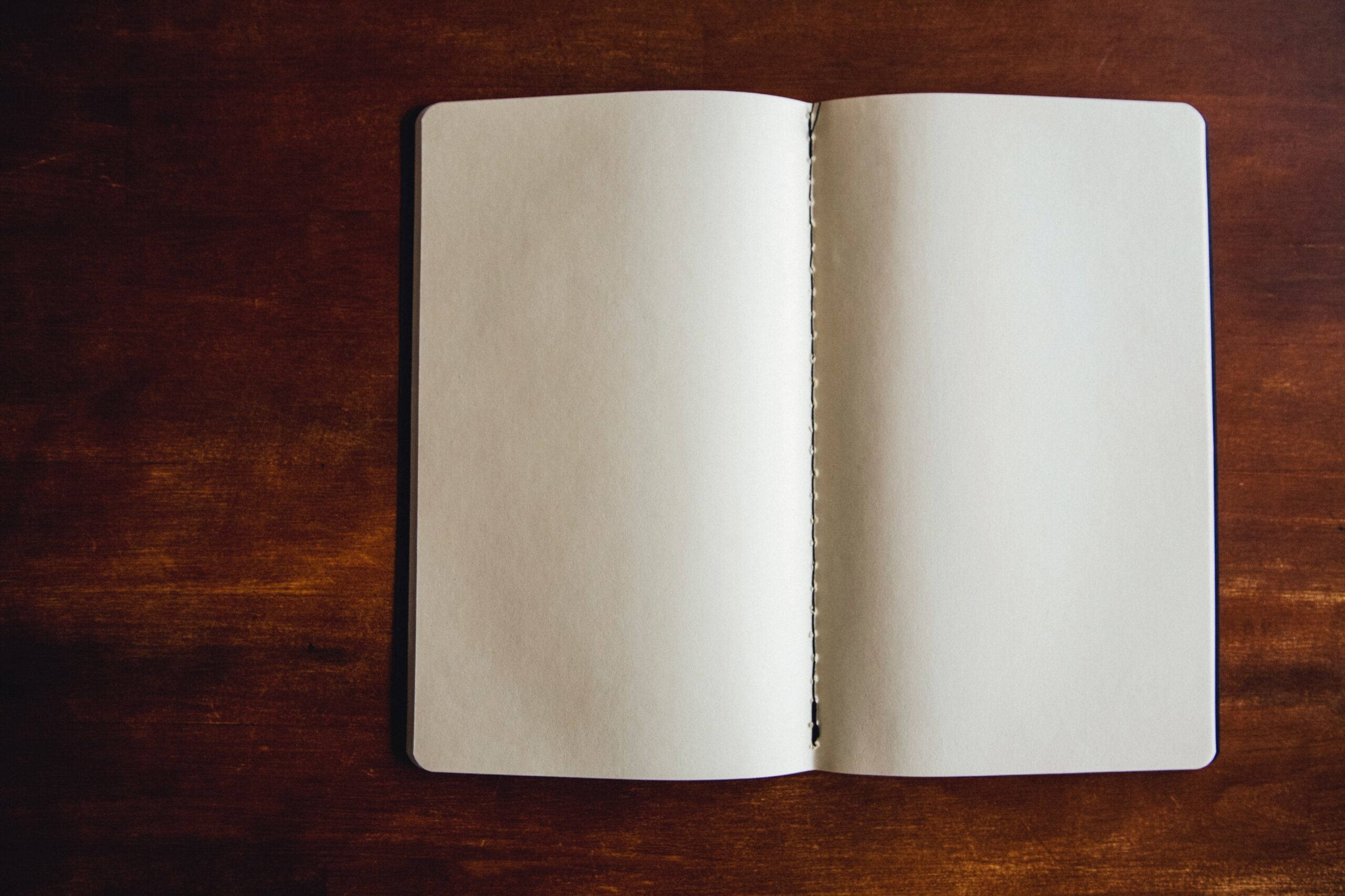 blank page notebook, dark wooden surface, 2K Desktop Wallpaper