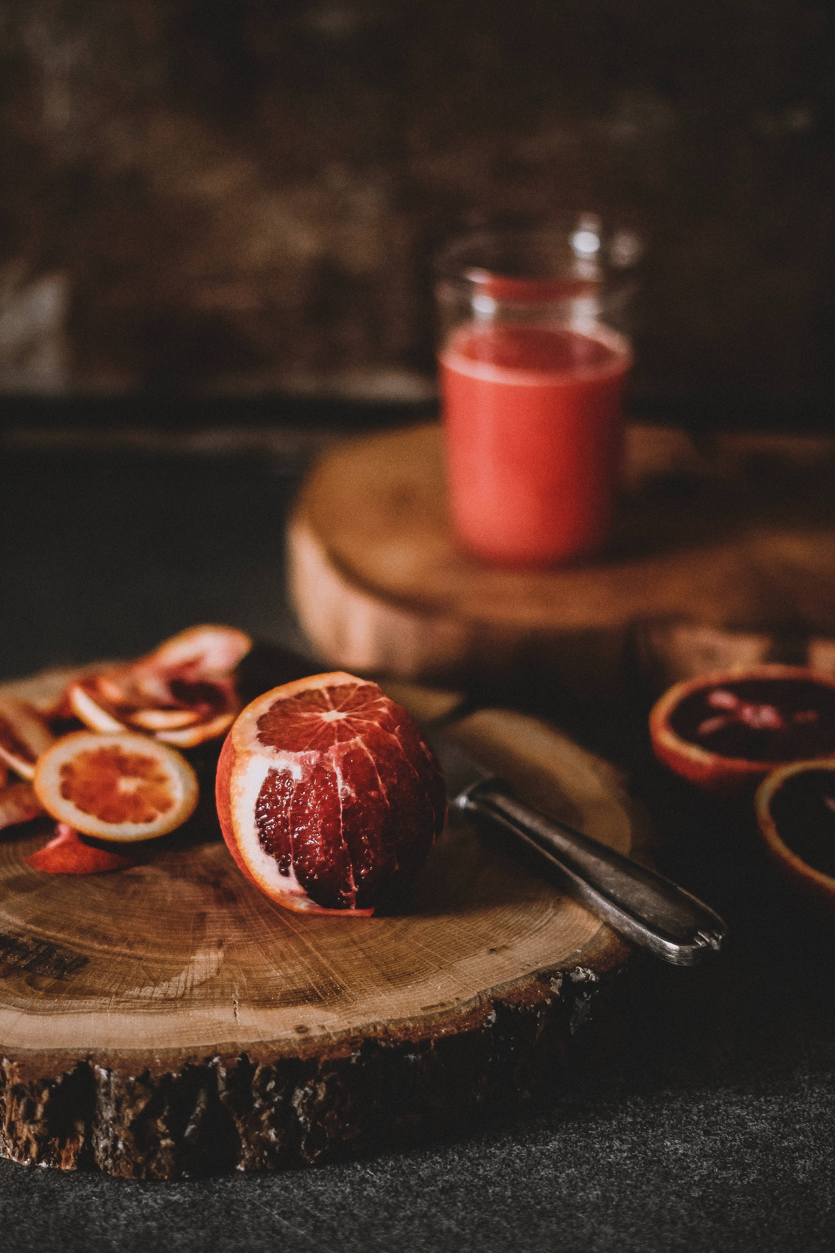 blood orange, vibrant red pulp, rustic wooden board, 4K Phone Wallpaper