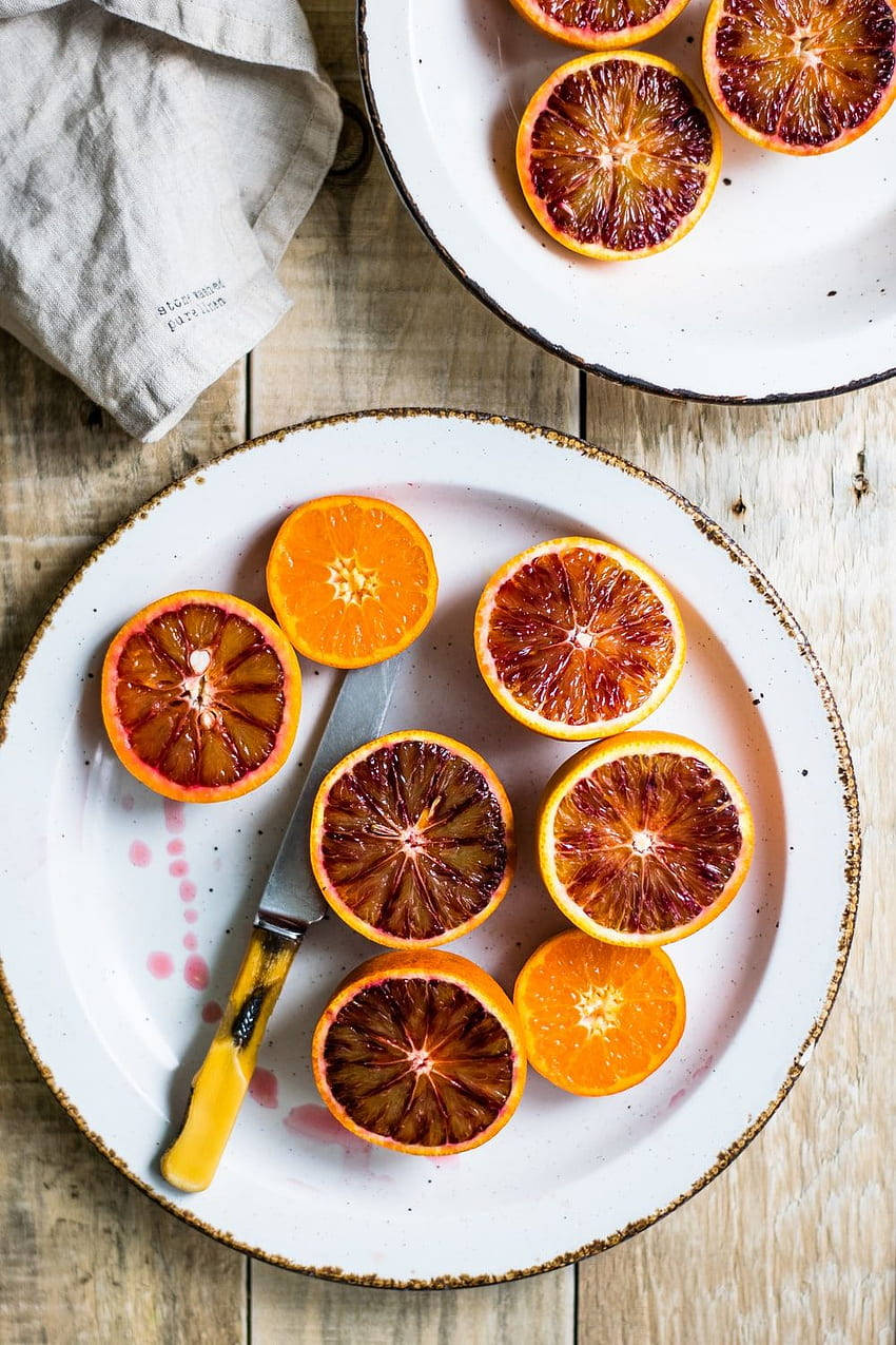 Blood Orange, crimson pulp, rustic white plates, SD Phone Wallpaper