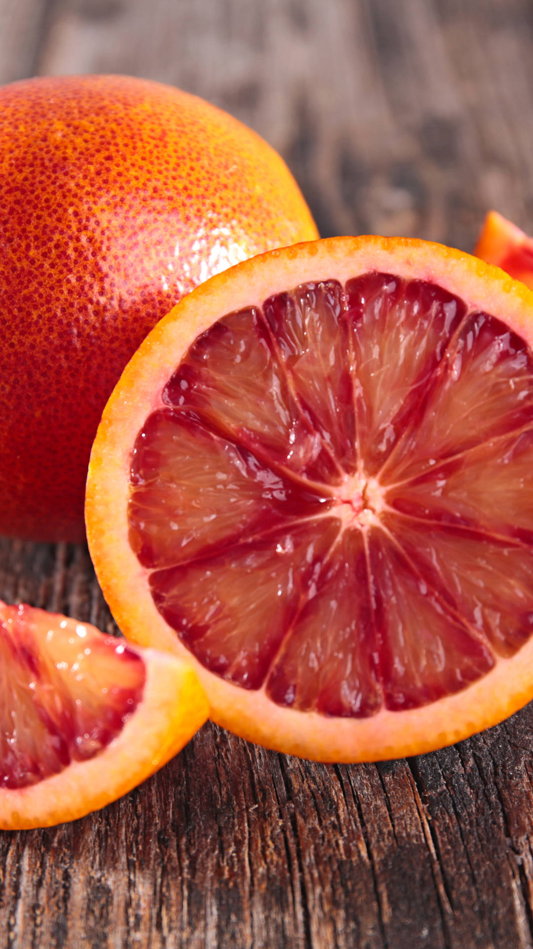 blood orange, crimson flesh, rustic dark wood surface, Full HD Phone Wallpaper