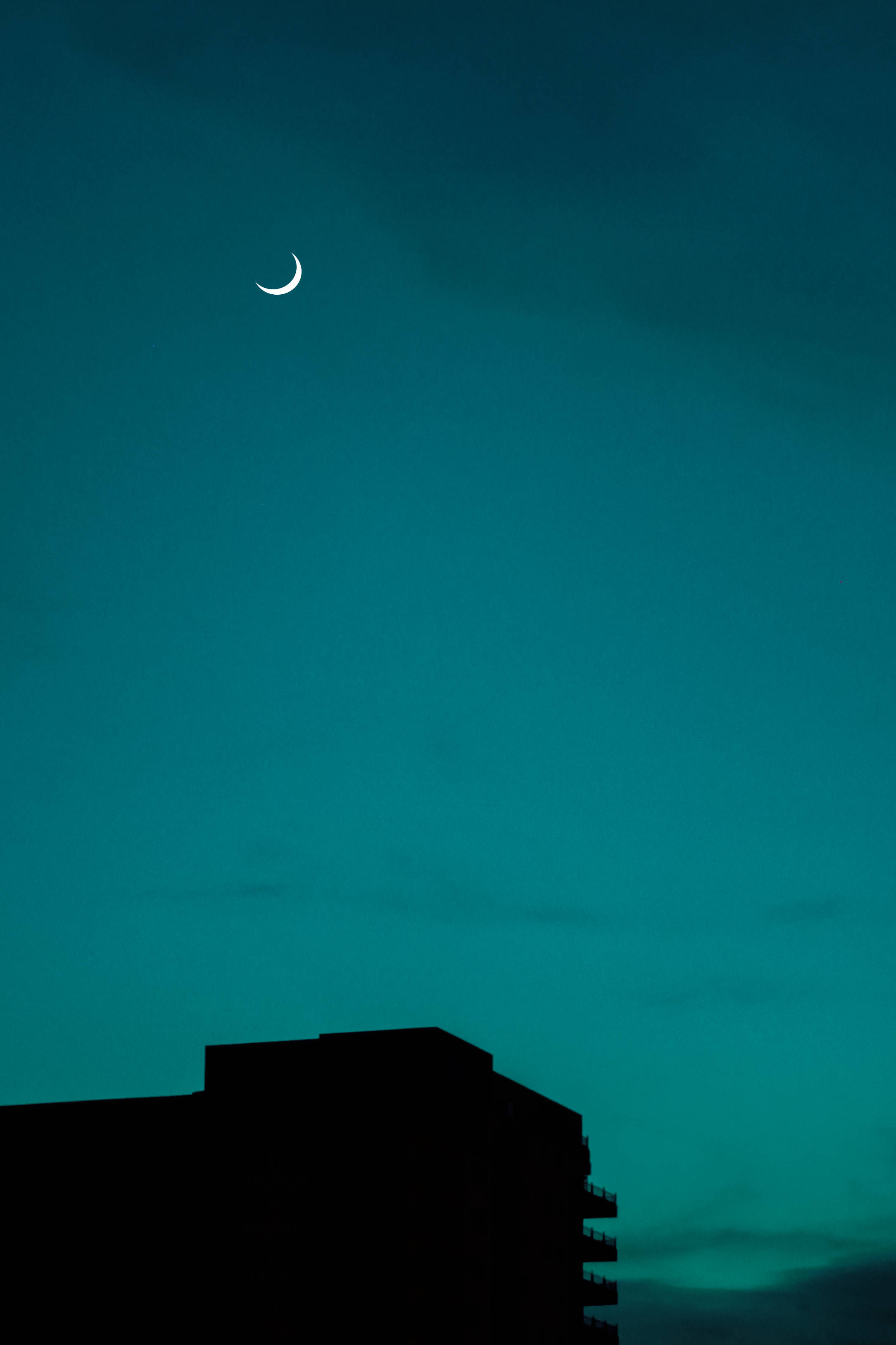 crescent moon, deep teal twilight sky, modern building, 2K Phone Wallpaper