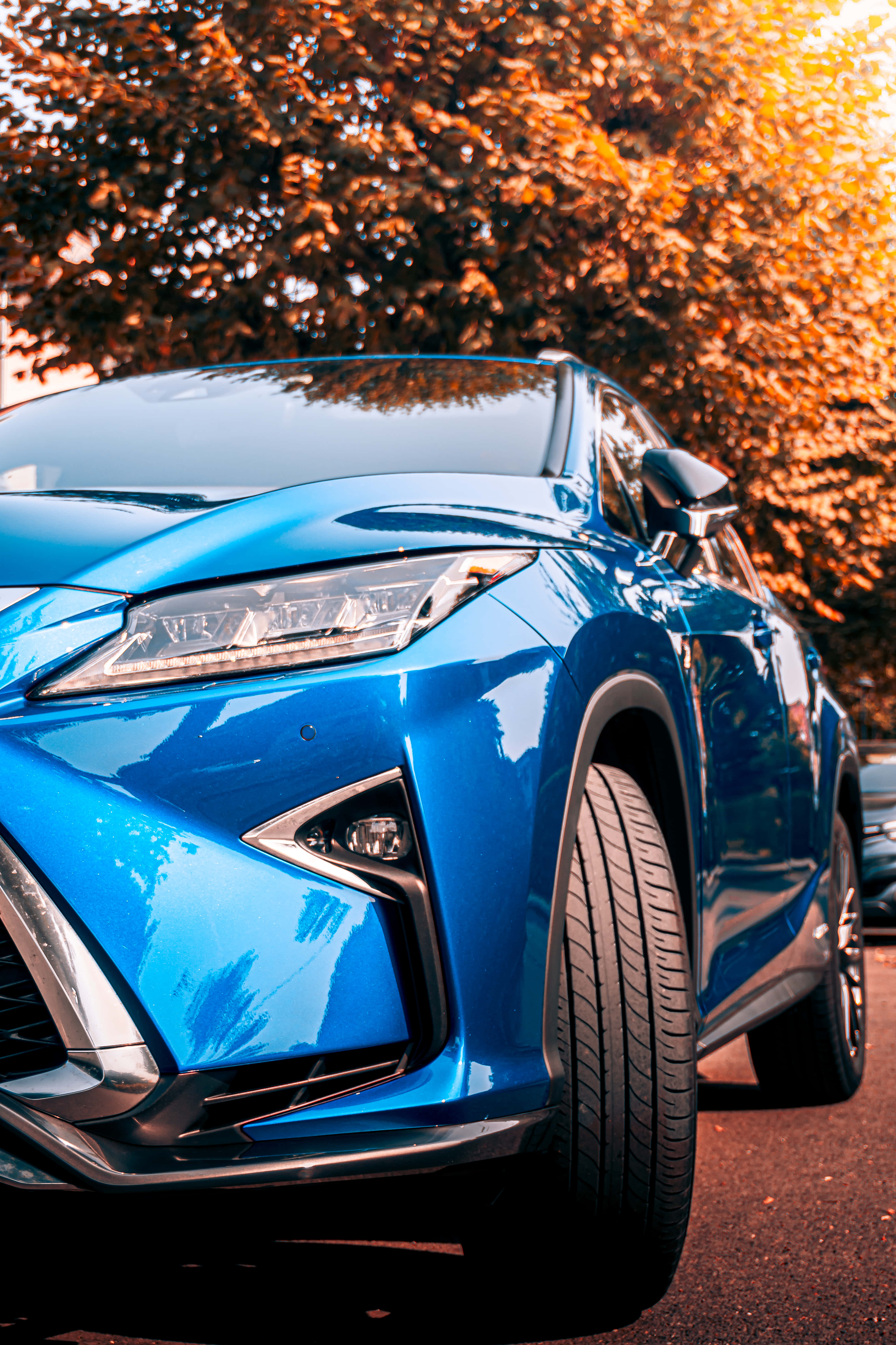 sleek blue car, glossy blue SUV, golden sunset light, 5K Phone Wallpaper