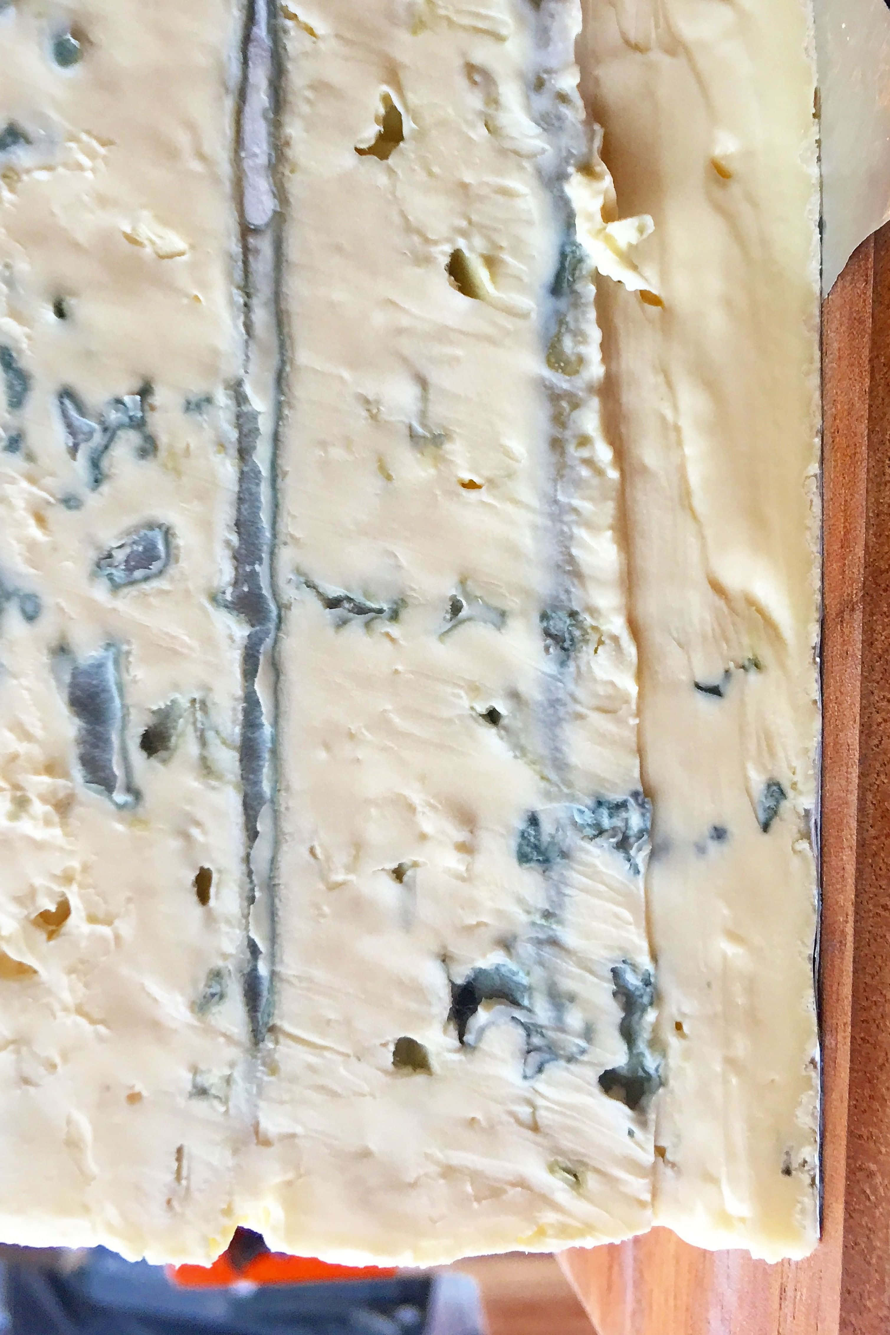 blue cheese, wooden cutting board, marbled blue veins, 4K Phone Wallpaper