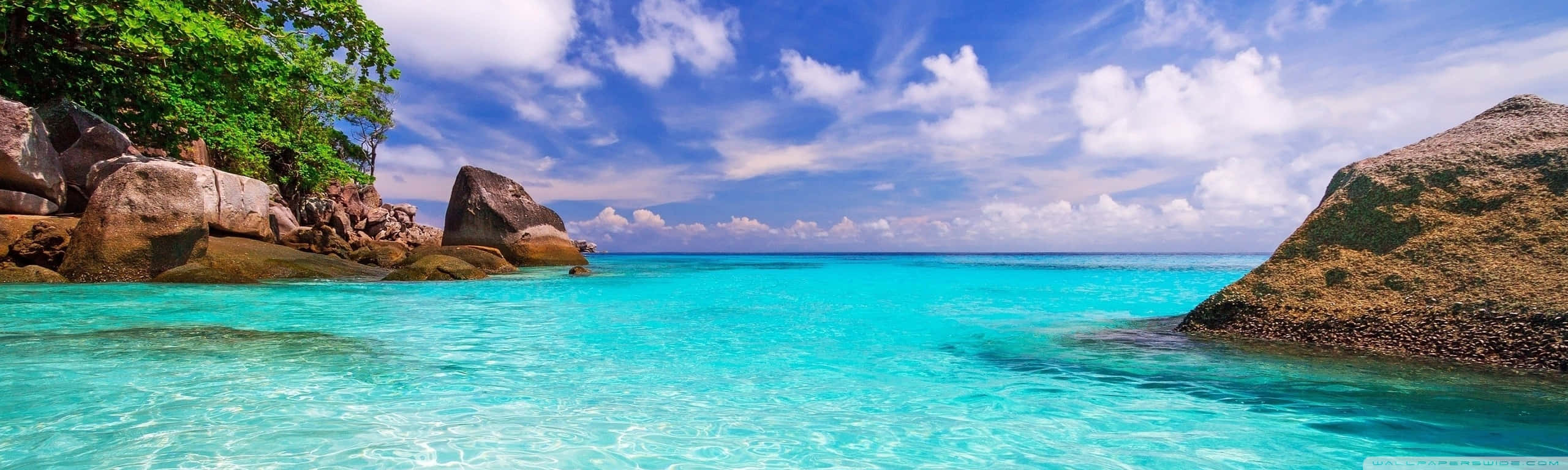 eyefinity, turquoise water, rugged tropical rocks, 2K Desktop Wallpaper