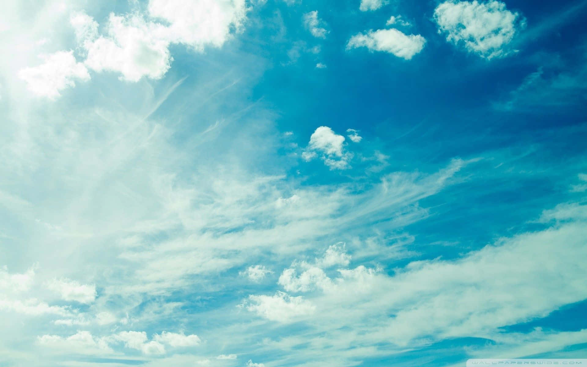 blue sky, fluffy white clouds, soft sun rays, Full HD Desktop Wallpaper