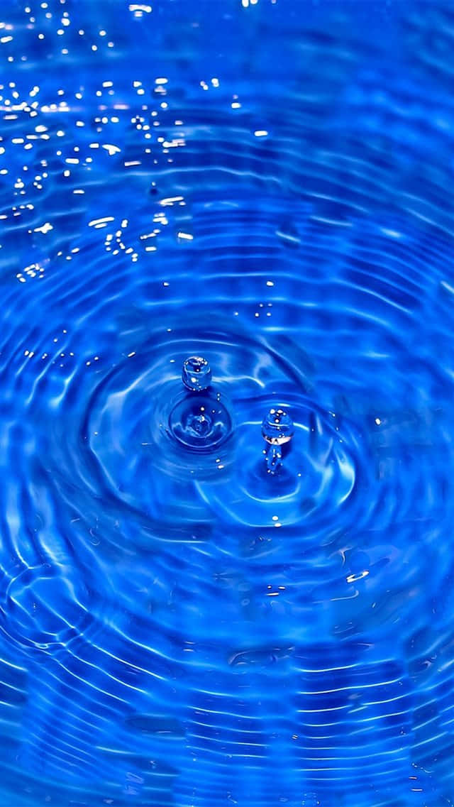 Blue iPhone XR, vibrant blue water surface, concentric ripples, SD Phone Wallpaper