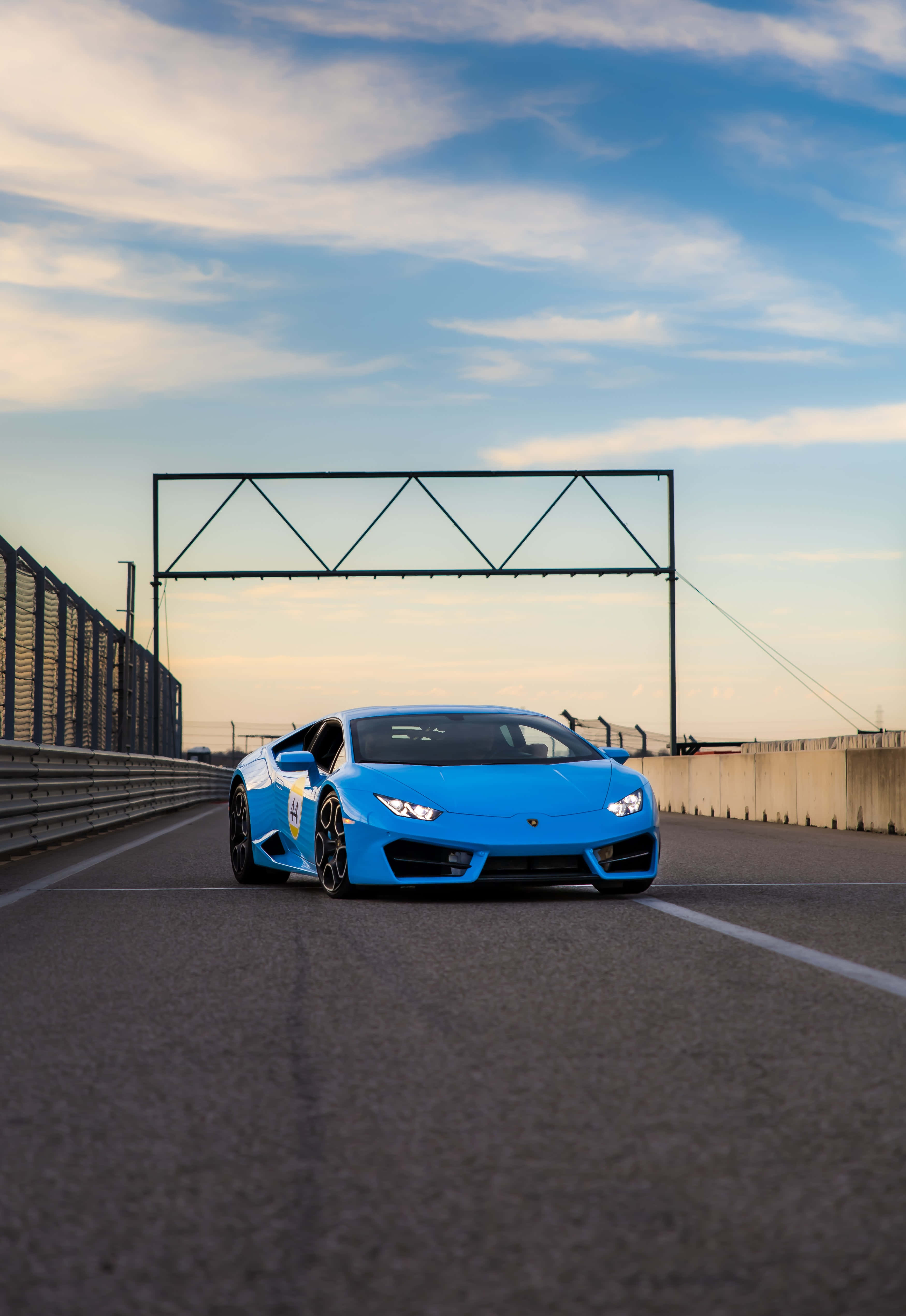 blue Lamborghini, racetrack, golden sunset sky, 4K Phone Wallpaper